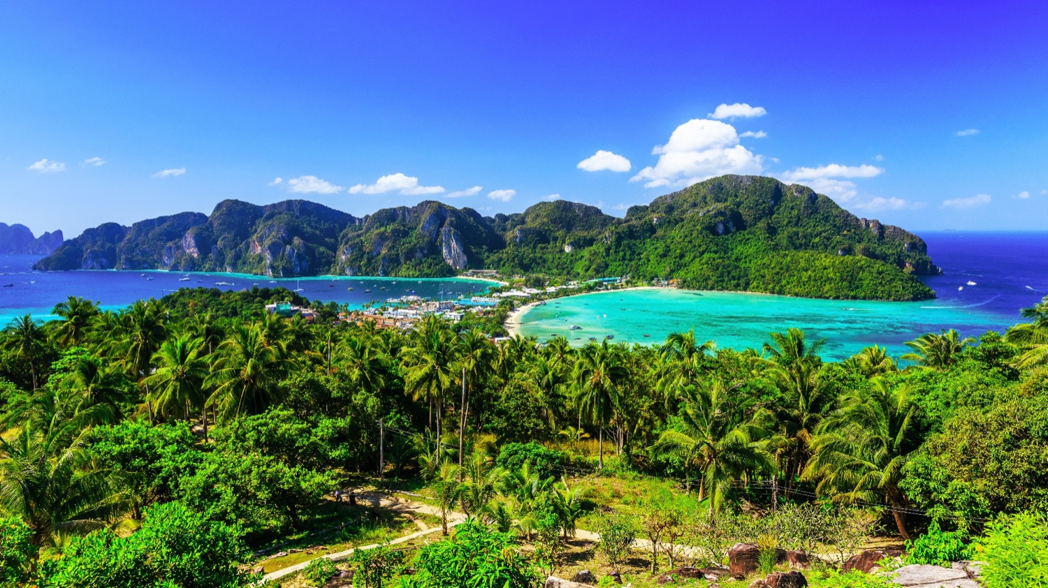 Stunning tropical landscape of Phi Phi Islands, Thailand, with turquoise bays and lush green hills.
