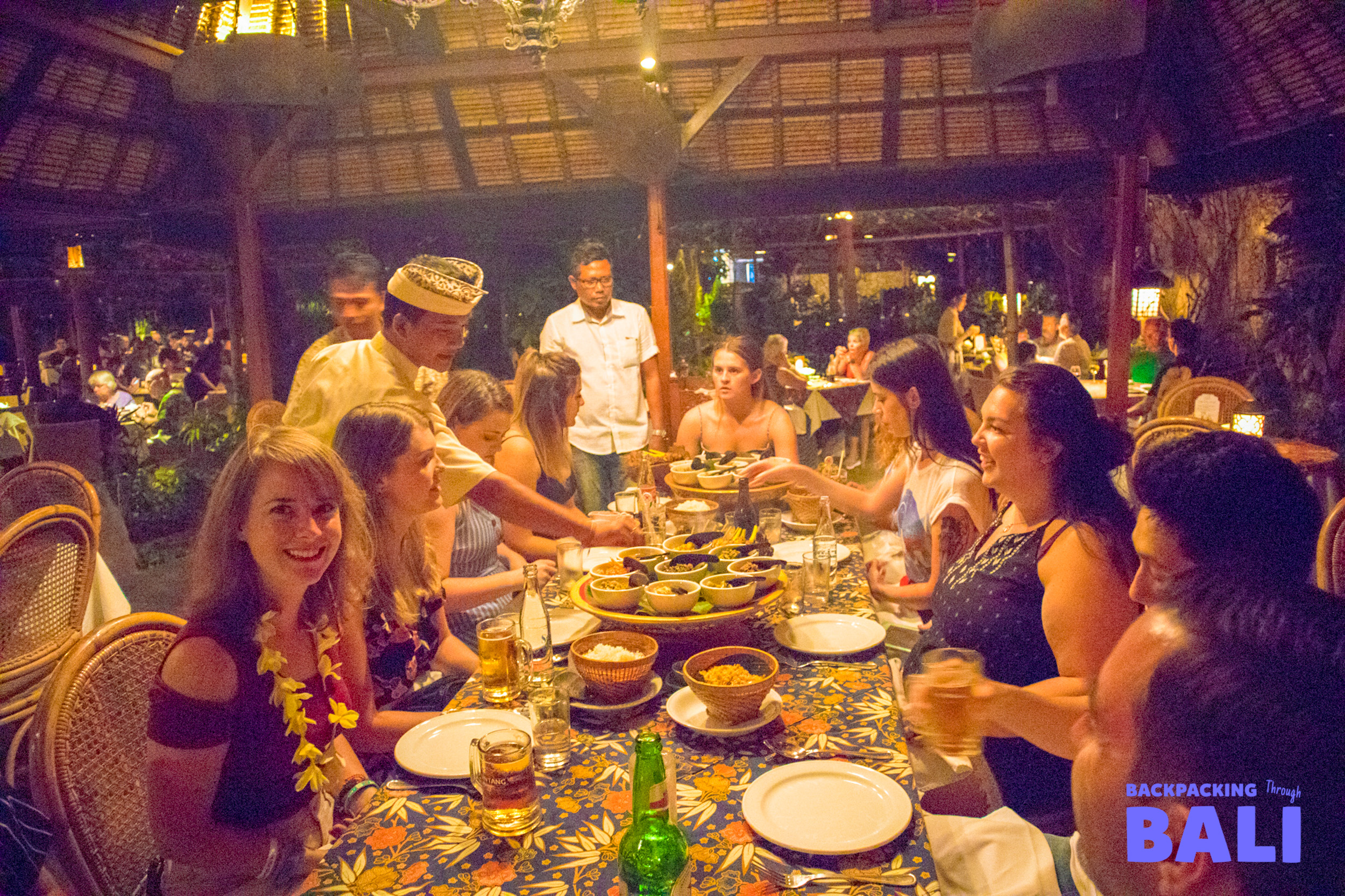 Backpacking group enjoying dinner together at a Balinese restaurant
