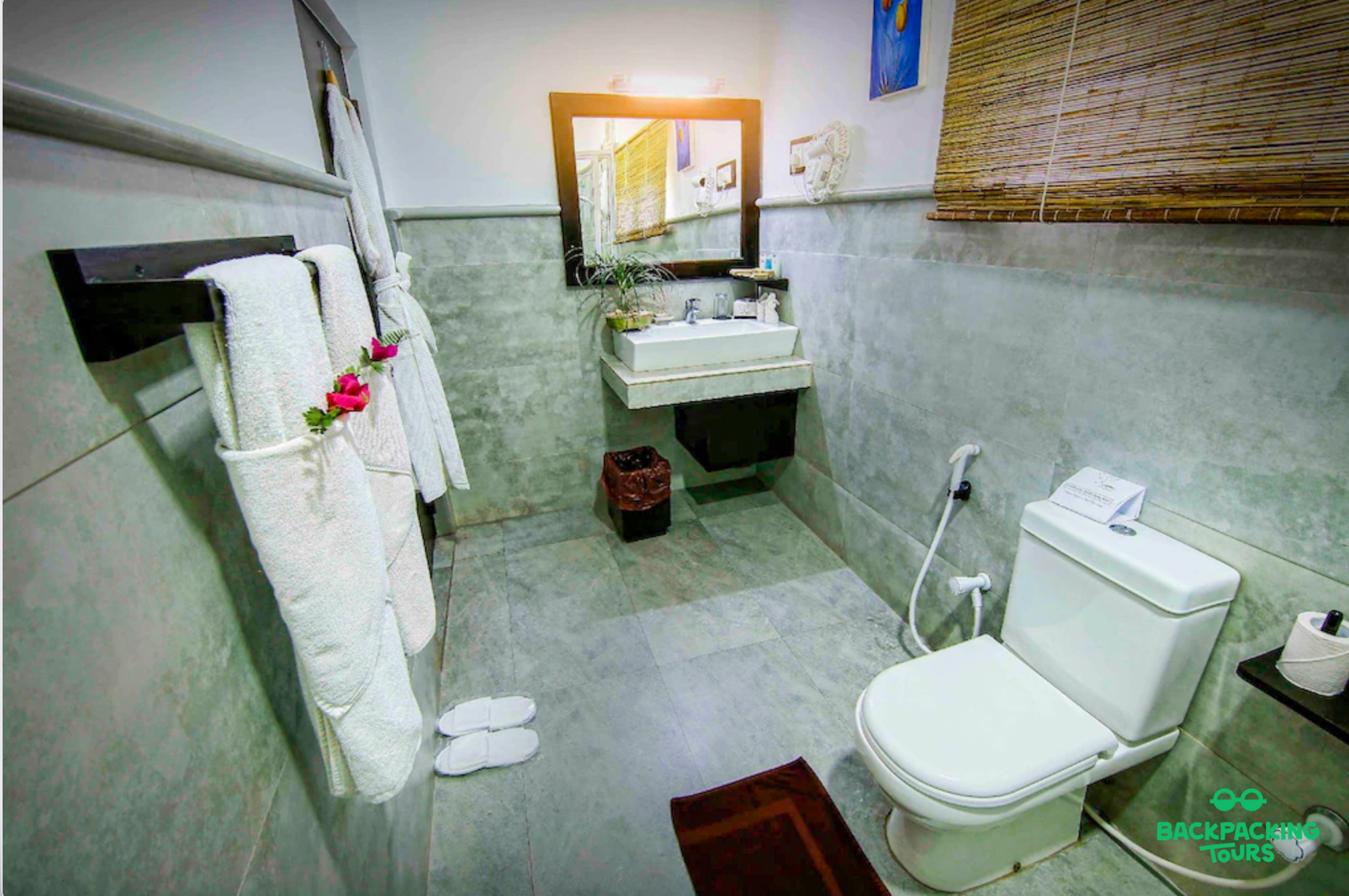 A clean and comfortable hotel bathroom with fresh towels and bathrobes, ready for guests in Sri Lanka.