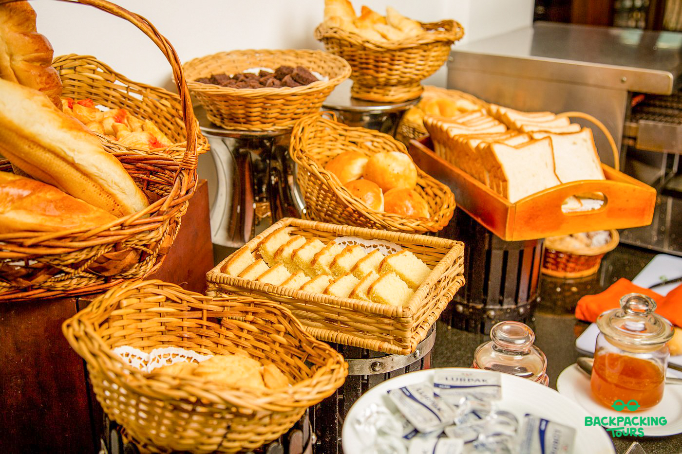 A tempting breakfast buffet with fresh breads, pastries, and spreads at your Sigiriya accommodation.