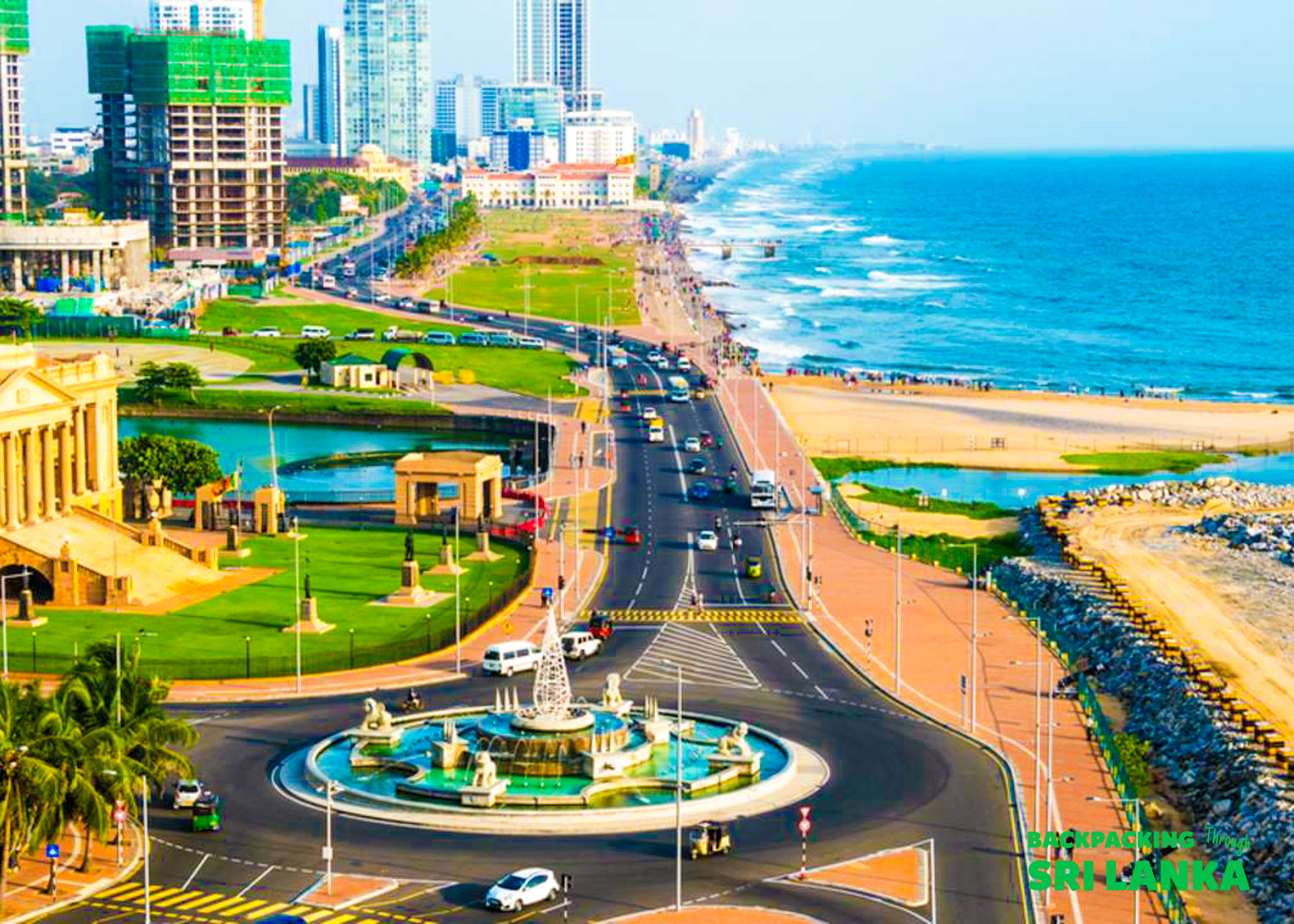Colombo's vibrant coastal city scene with a busy road, modern buildings, and a long sandy beach.