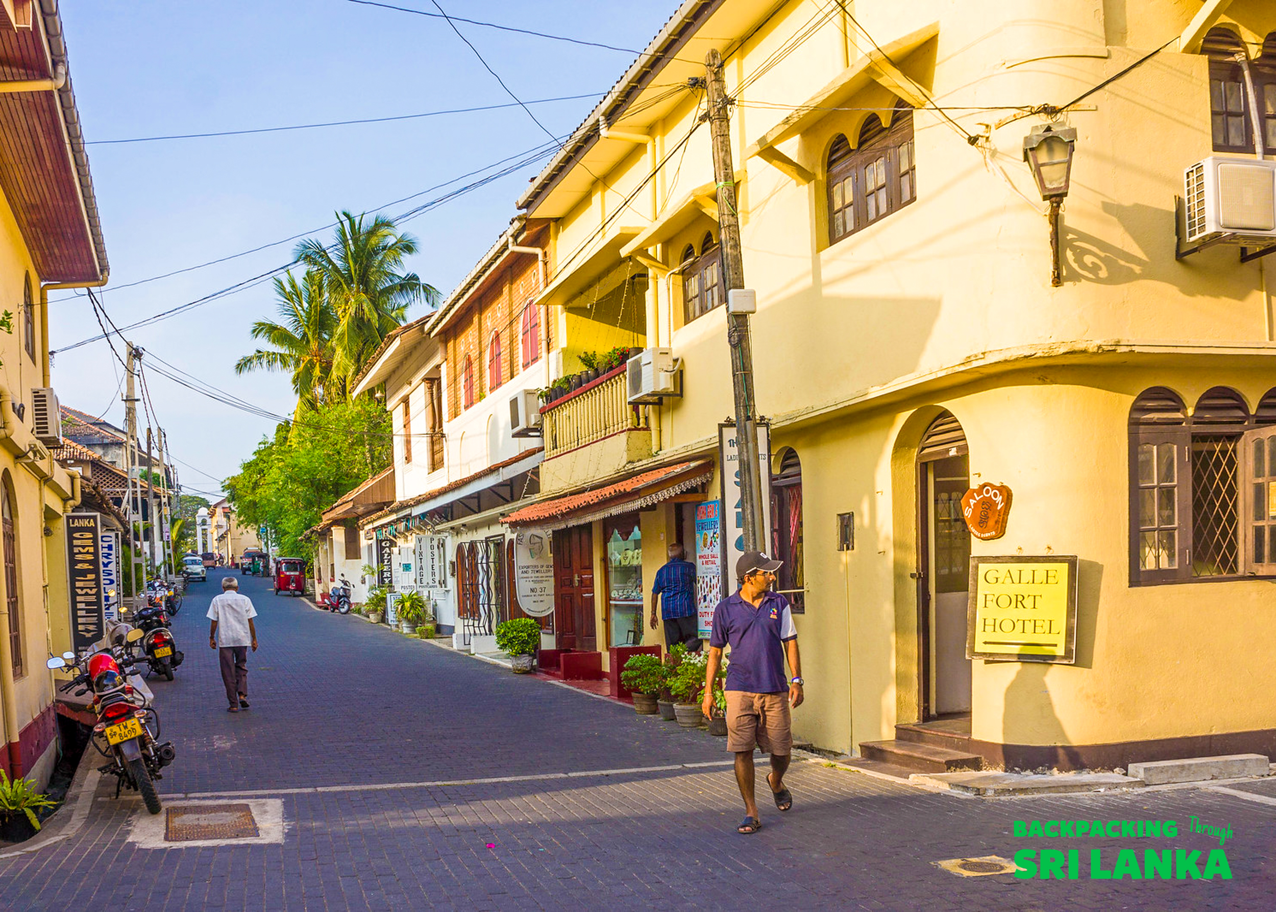 People stroll along a charming street with colonial architecture in Galle Fort, Sri Lanka.