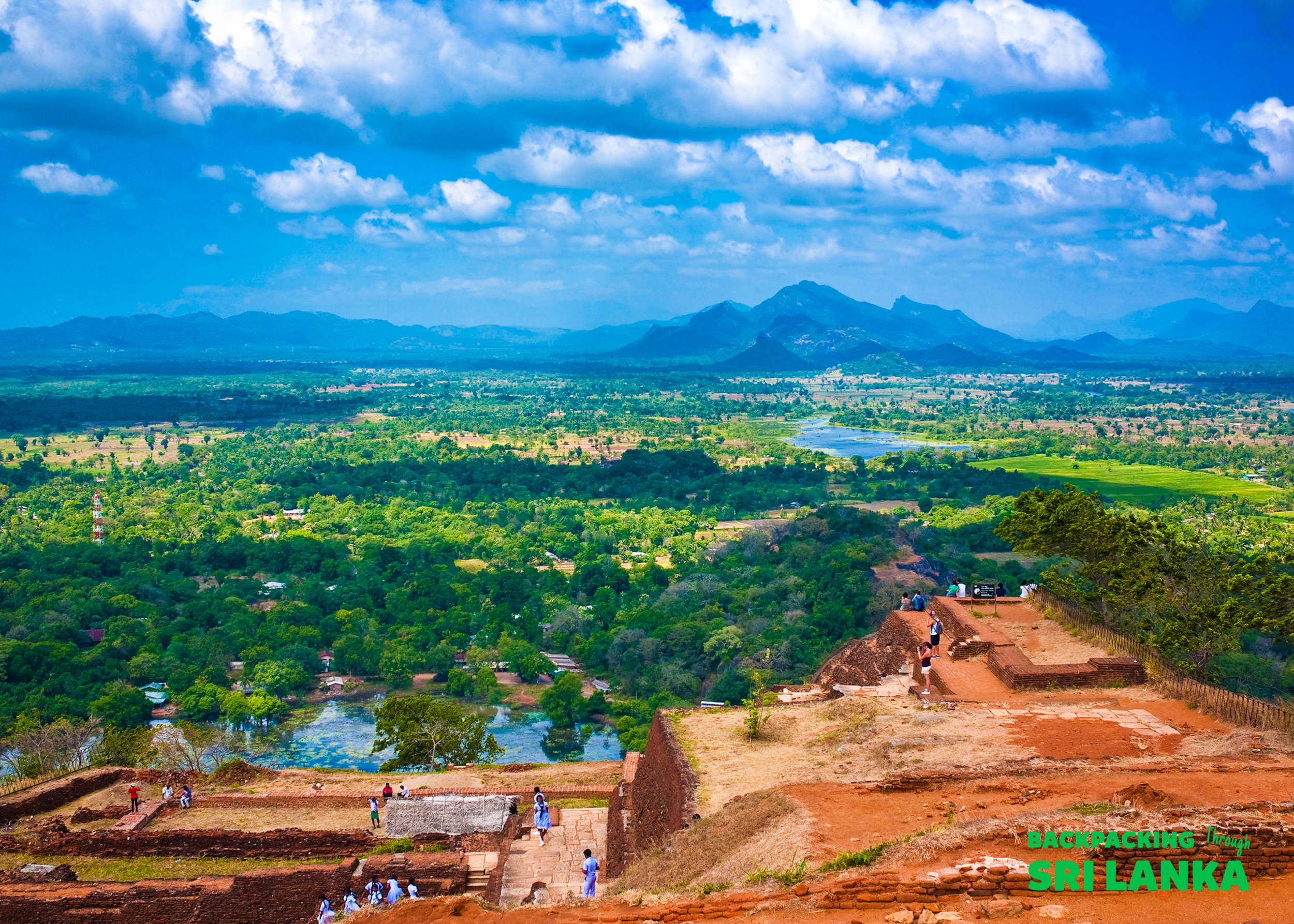Exploring the historic Sigiriya rock fortress, with breathtaking views of Sri Lanka's green plains and distant mountains.