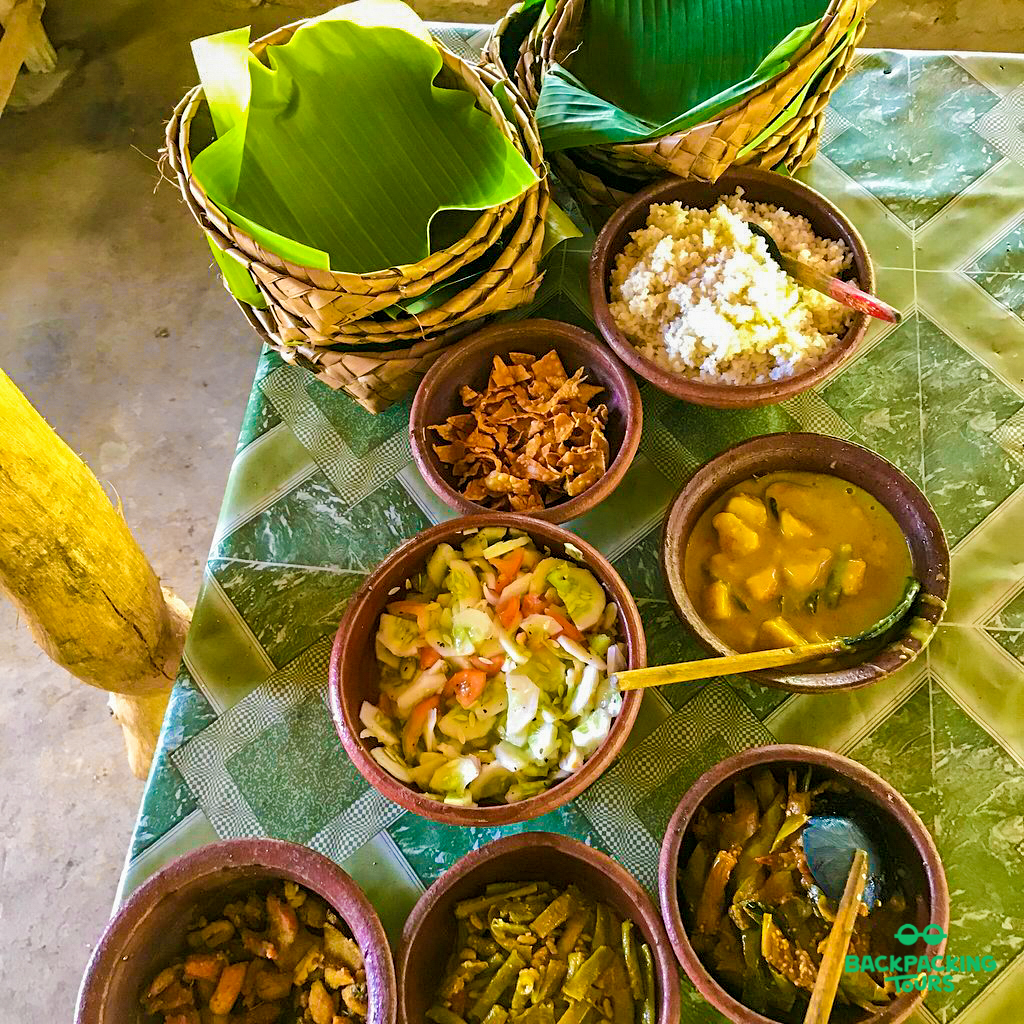 A delicious Sri Lankan village lunch with rice, various curries, and fresh salad.