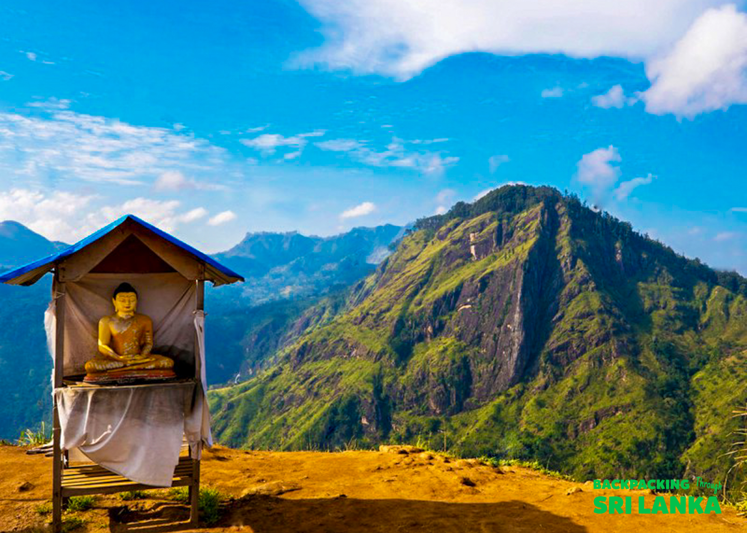 A golden Buddha statue in a shrine overlooks the dramatic, lush green mountains near Ella, Sri Lanka.