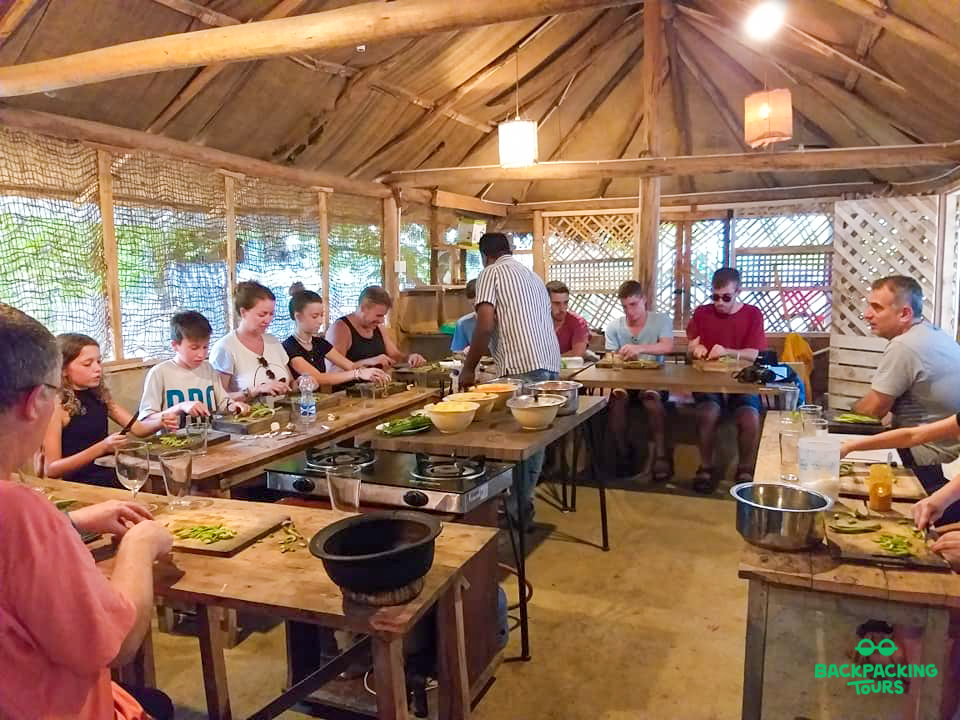 Travelers participate in a hands-on Sri Lankan cooking class with a local instructor in Ella.