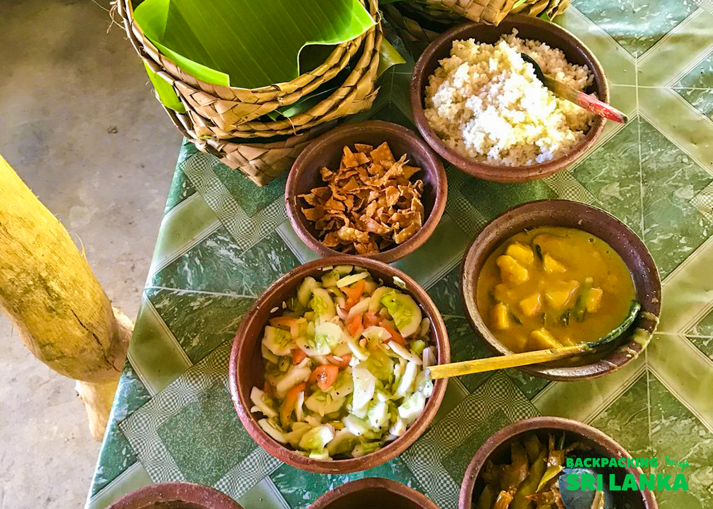 Delicious Sri Lankan curries, rice, and fresh salad served in wooden bowls during a cooking class in Ella.