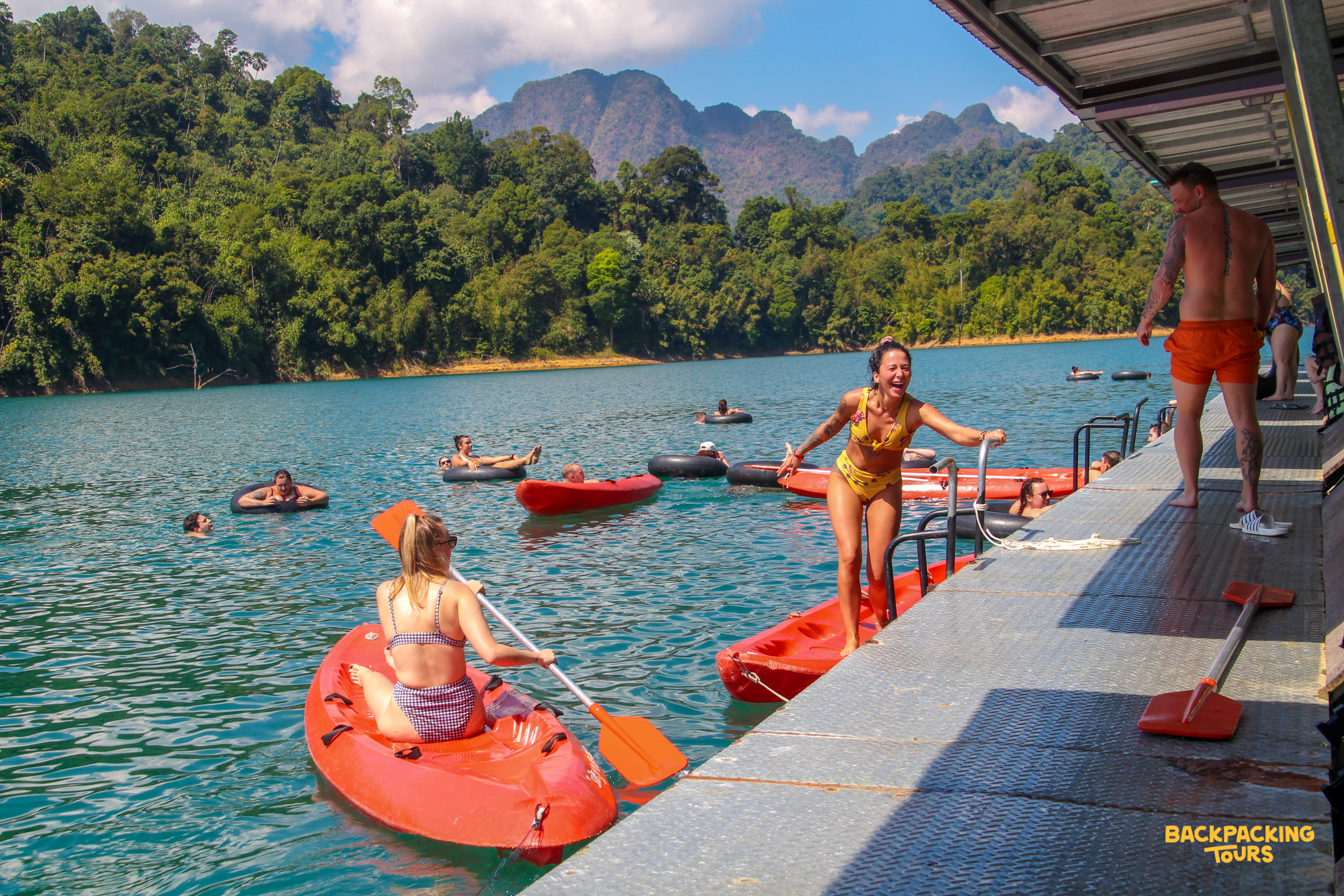 Backpackers kayaking on Cheow Lan Lake, Khao Sok.
