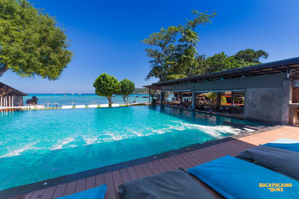 Relaxing by the beautiful turquoise pool with ocean views at a resort in Koh Phi Phi.