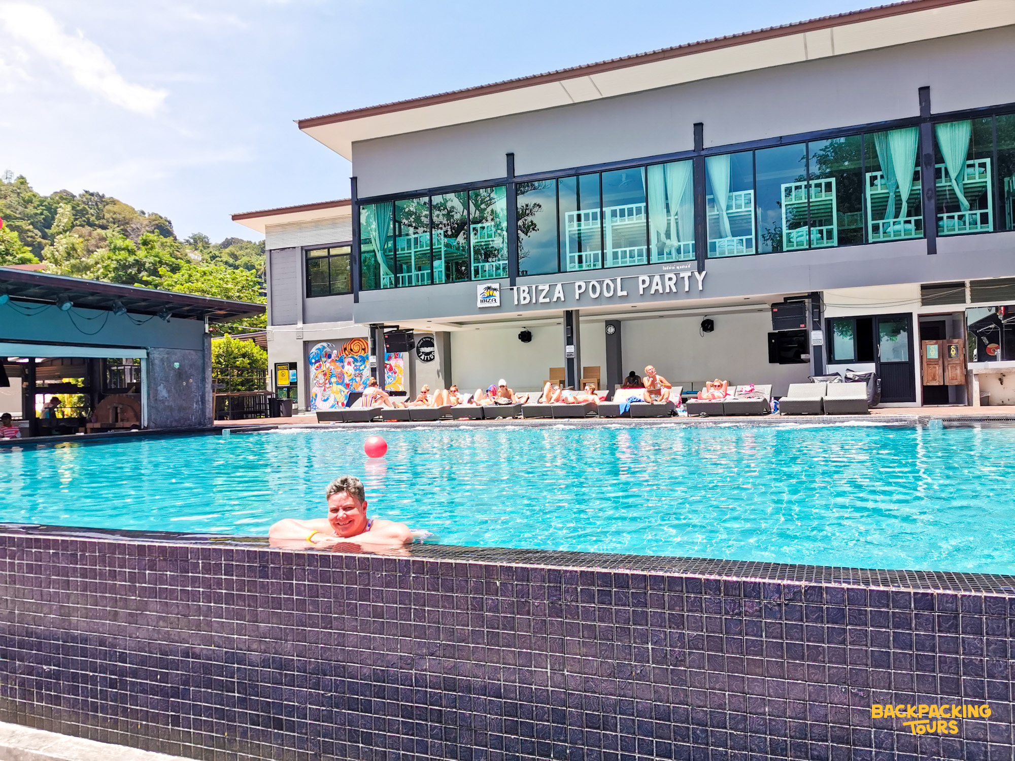 Guests relax and swim at the Ibiza Pool Party on sunny Koh Phi Phi island.