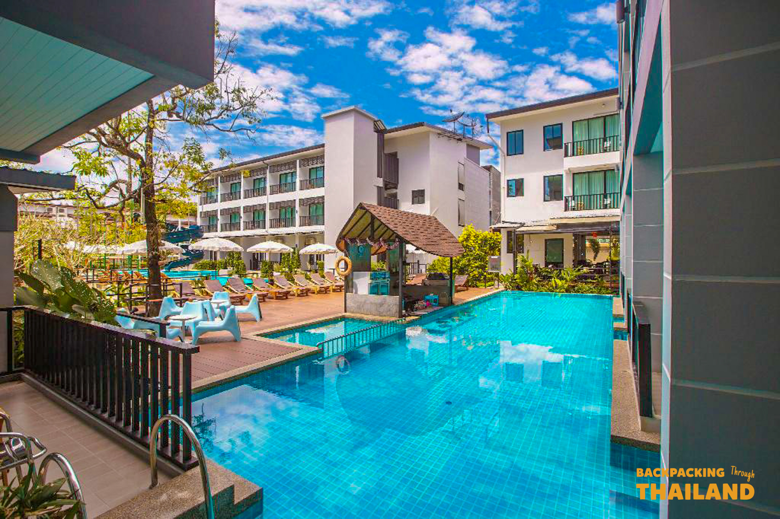 Hotel swimming pool in Ao Nang surrounded by buildings.