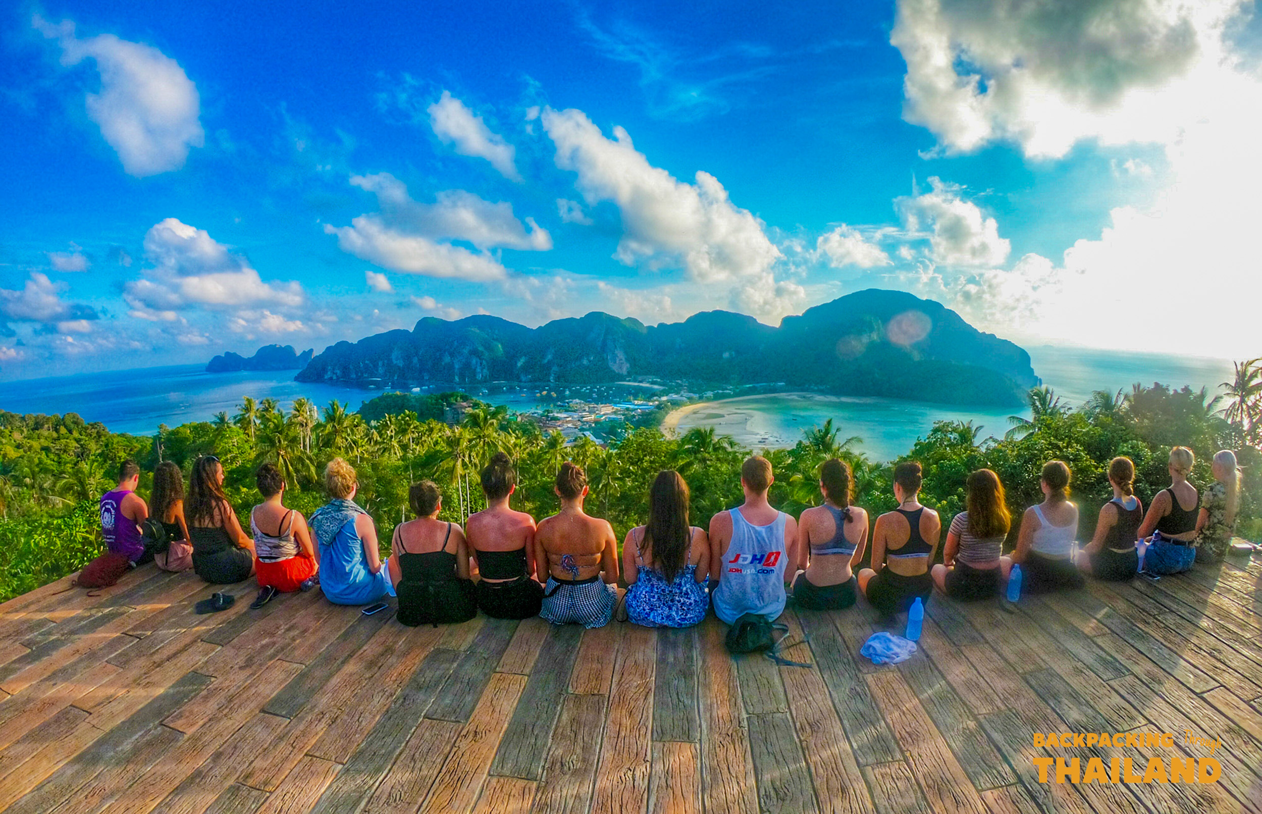 Backpackers enjoy the breathtaking panoramic view of Koh Phi Phi's twin bays from a high viewpoint.