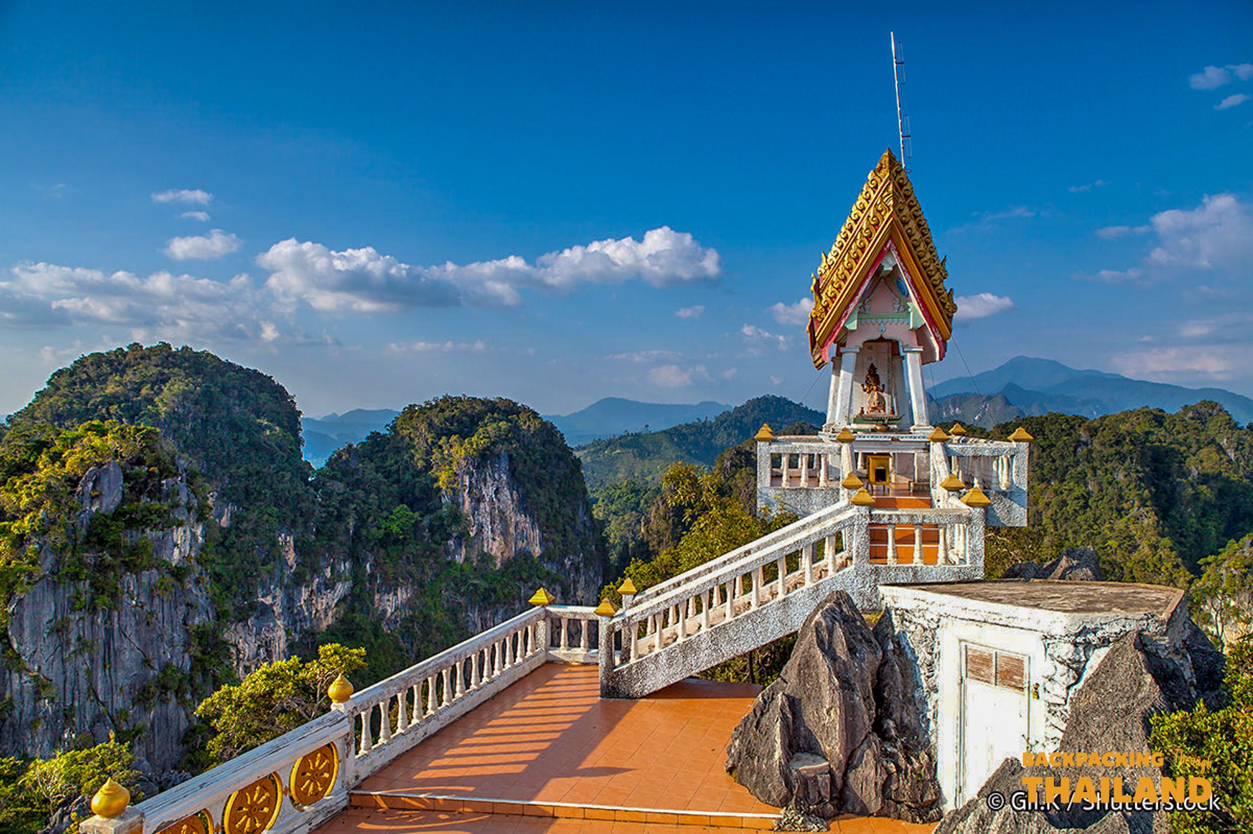 Panoramic view from Tiger Cave Temple, Krabi, showcasing the temple and surrounding lush karstic mountains.