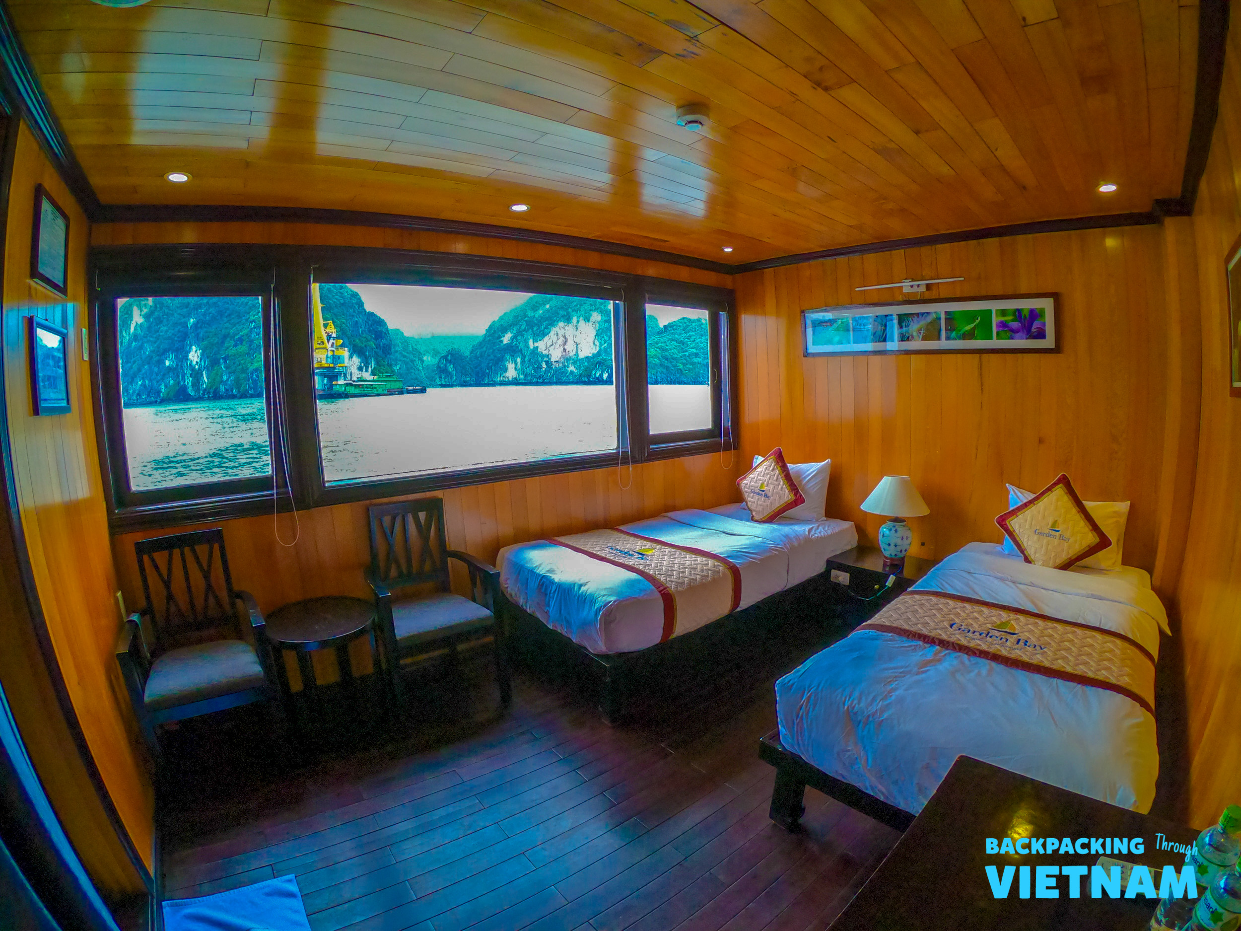 A cozy twin cabin on a sleeper boat, offering breathtaking views of Halong Bay.