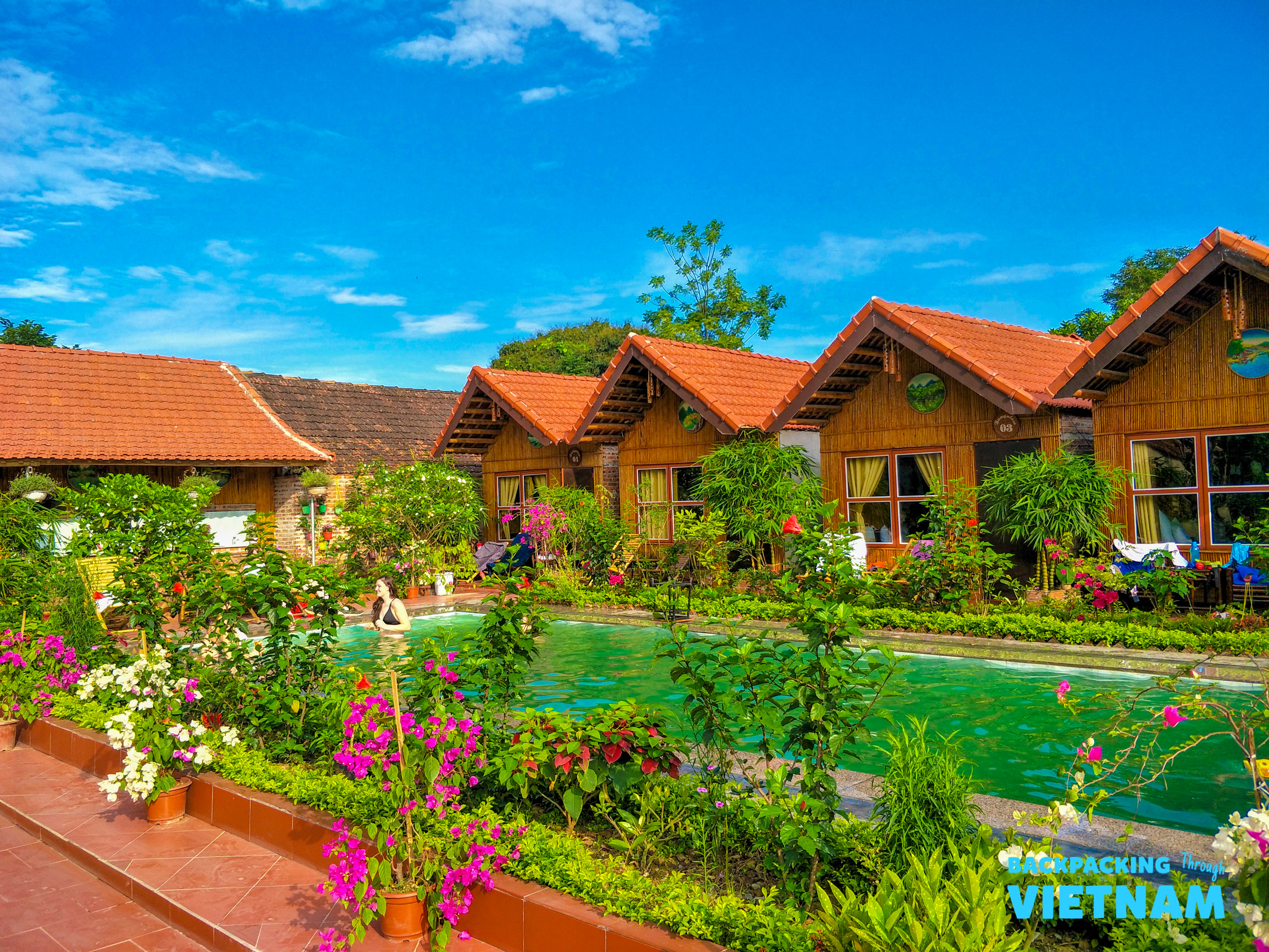 Peaceful resort bungalows with a refreshing swimming pool and colorful gardens in Tam Coc, Vietnam.