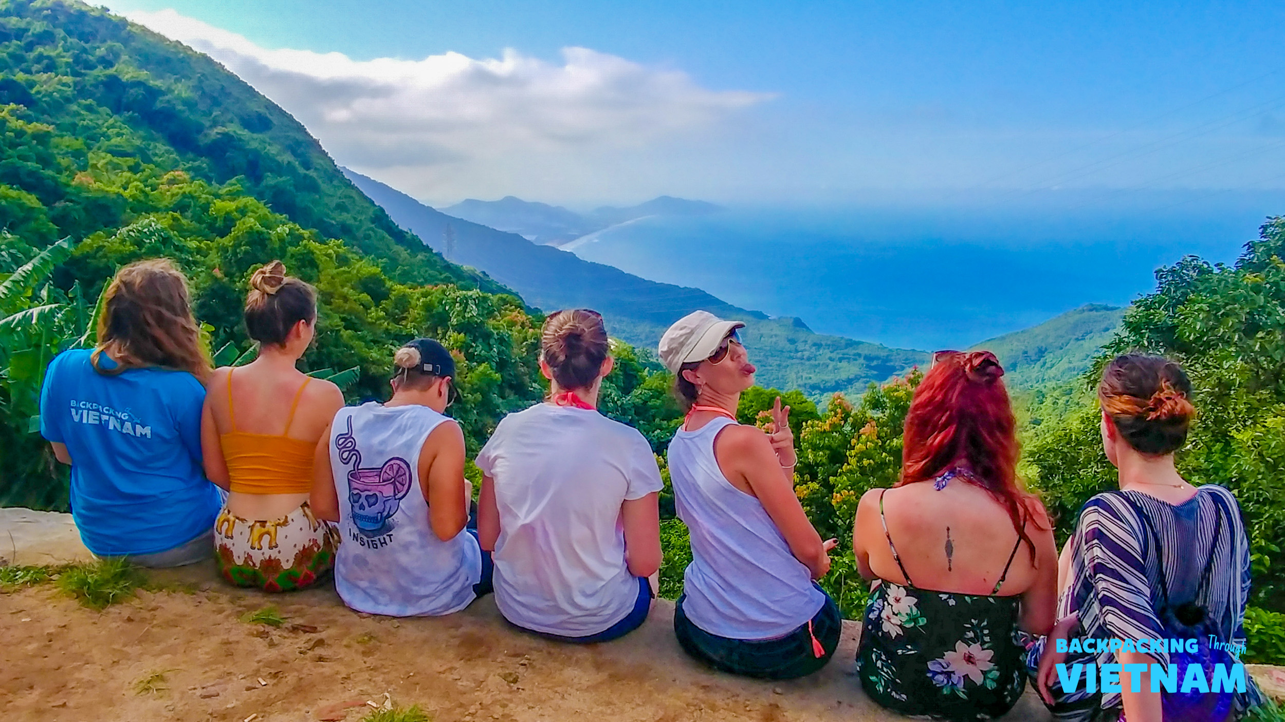 Friends enjoying panoramic coastal view on Hai Van Pass