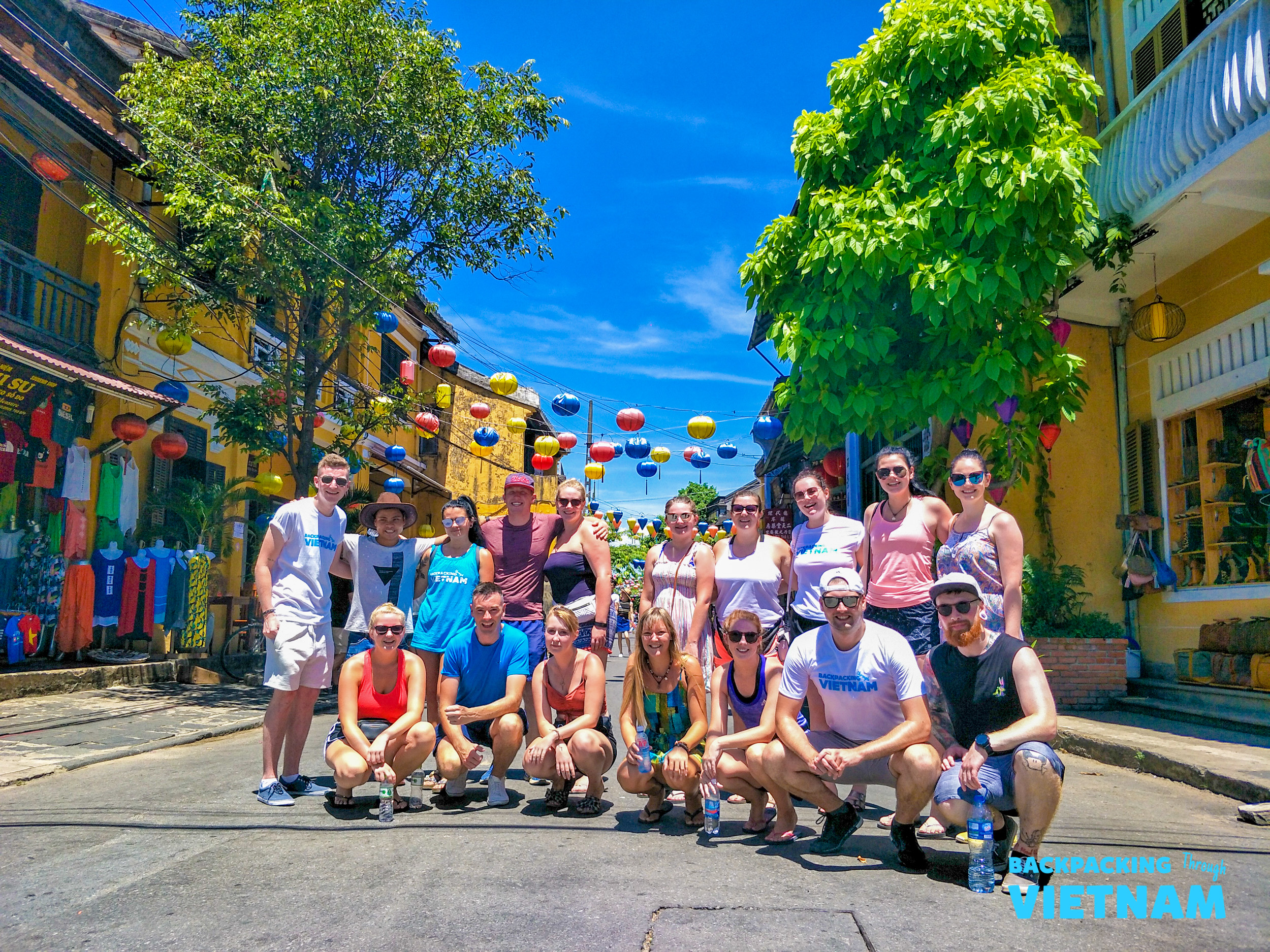 Backpacking group strolling in lantern-lit street in Hoi An
