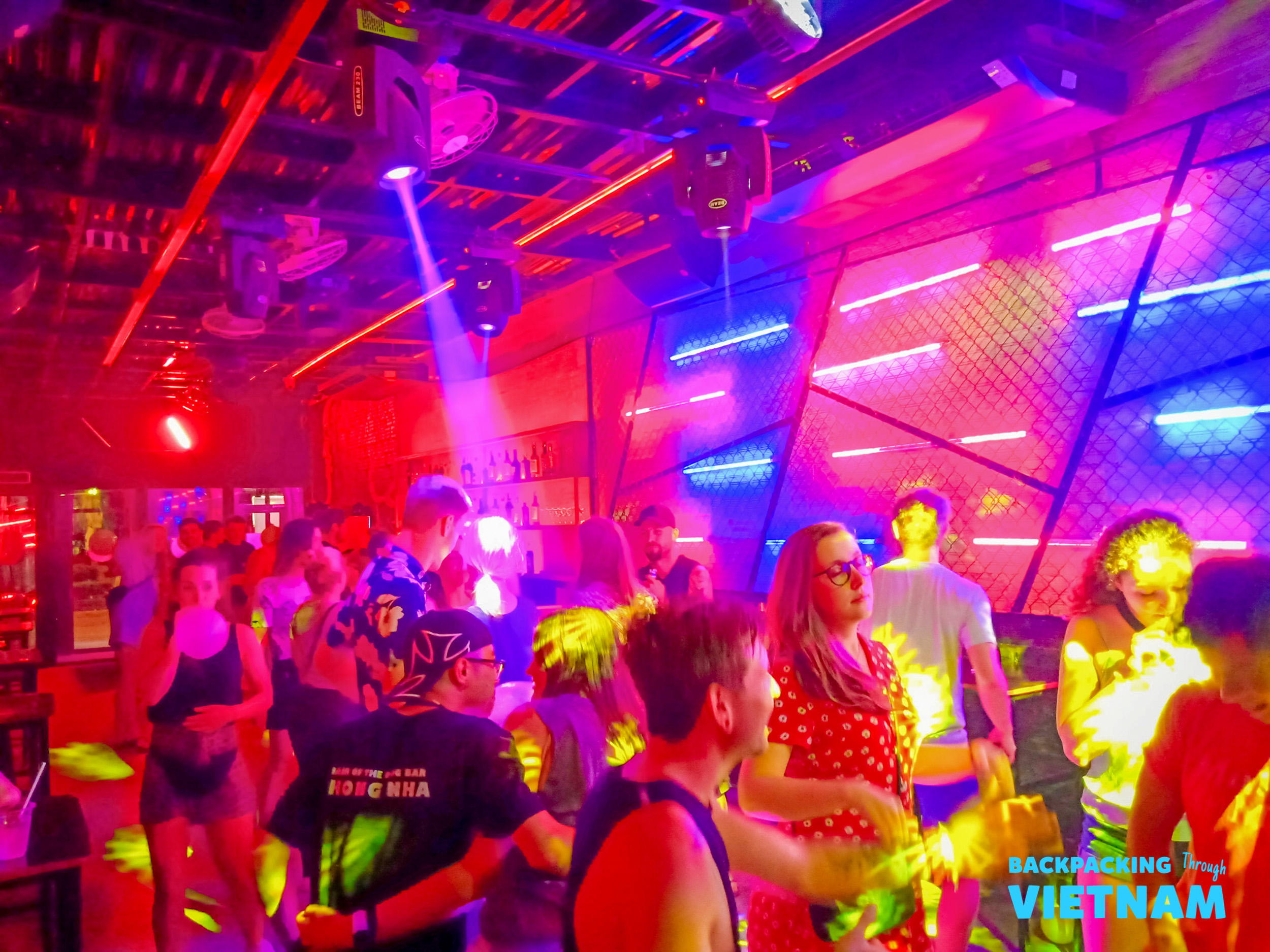 Young backpackers dancing and enjoying the vibrant nightlife in Phong Nha, Vietnam.