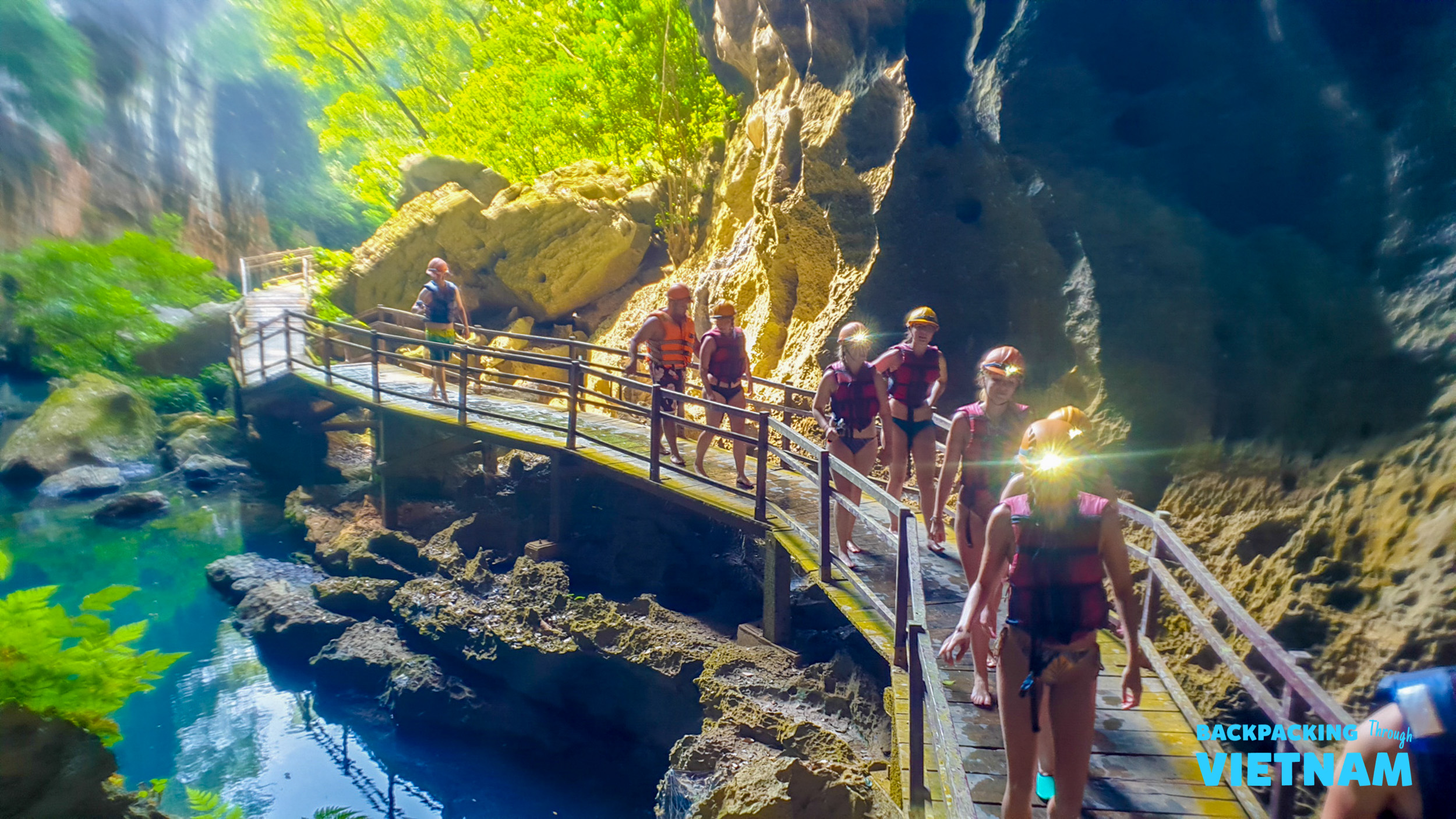 Backpacking group exploring Phong Nha Cave interior