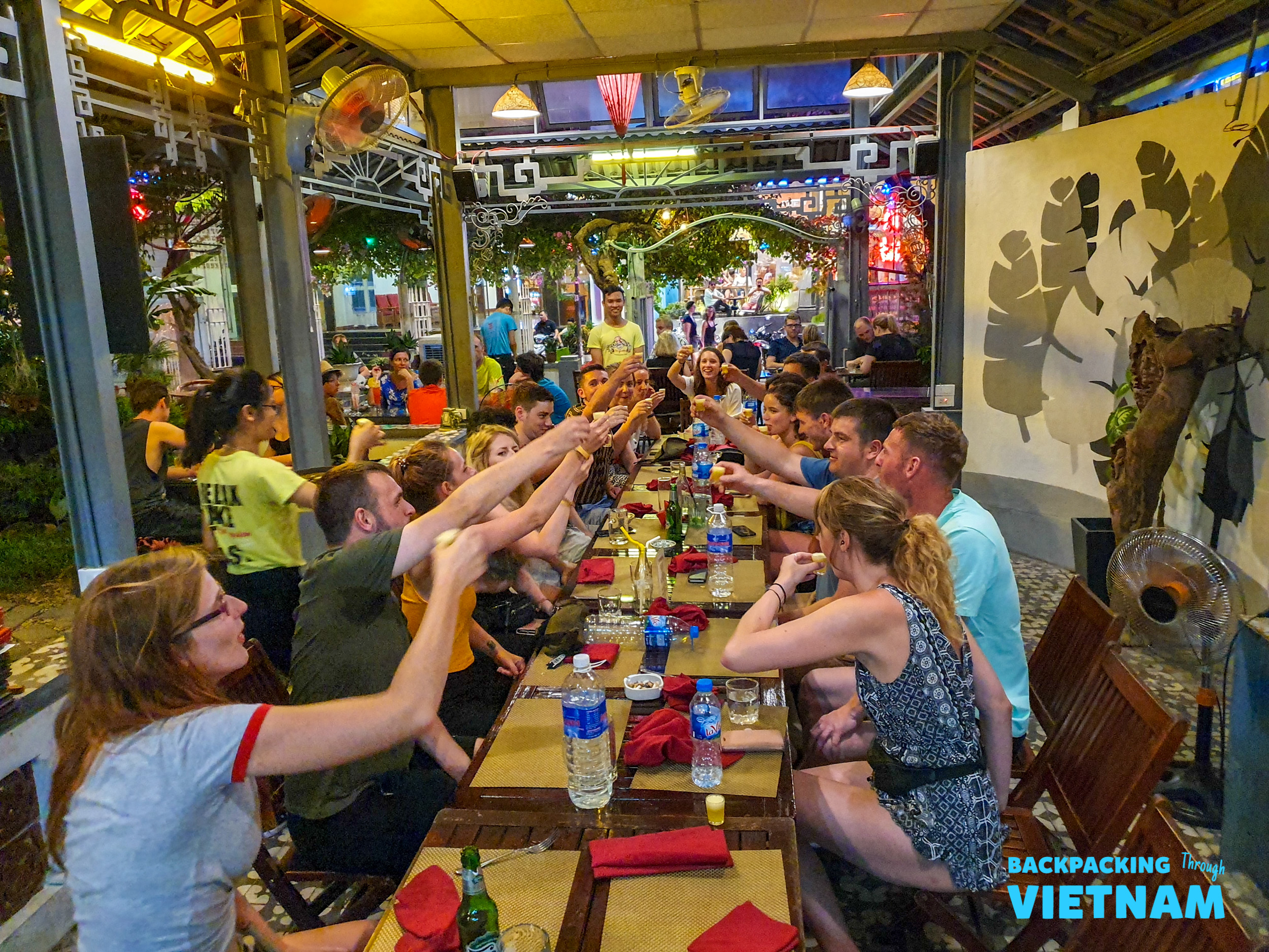 Backpacking group enjoying Vietnamese dinner in Hue