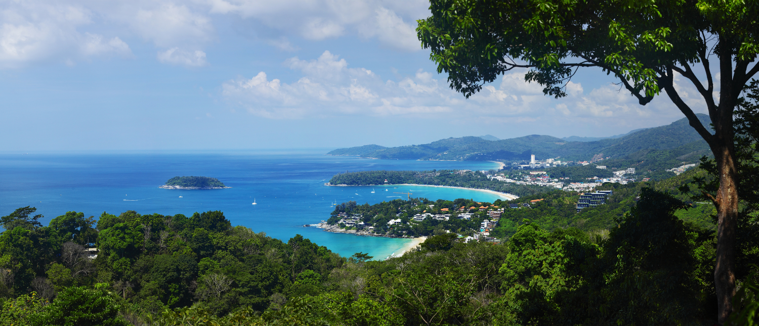 Panoramic view of three crescent beaches and turquoise bays from a lush green viewpoint in Phuket.