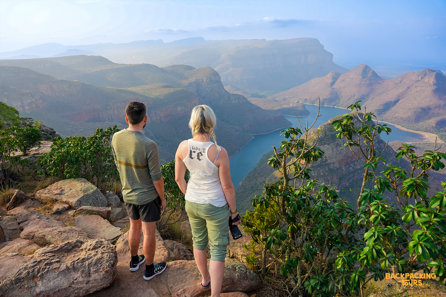 Two travelers admire the breathtaking views of Blyde River Canyon and its winding river.