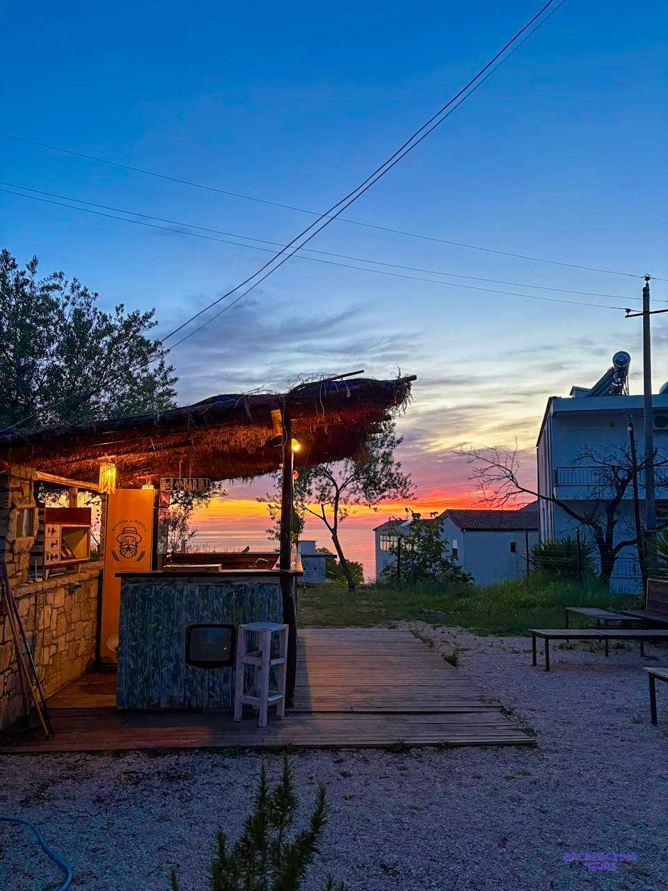 The outdoor bar of the hostel in Himarë at sunset