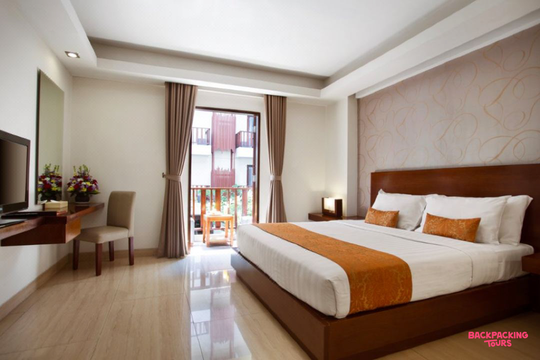 A modern and comfortable hotel room in Seminyak, Bali, with a large bed and private balcony.
