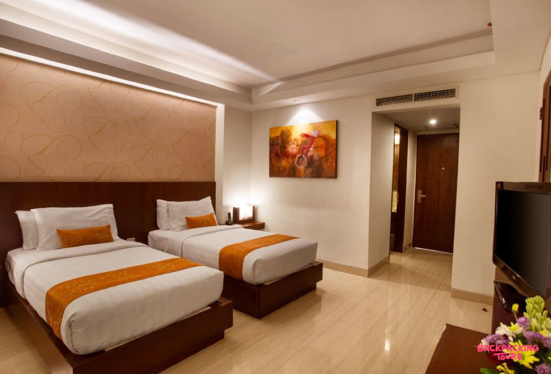 A comfortable hotel room in Seminyak with twin beds, modern decor, and a clean, inviting atmosphere.
