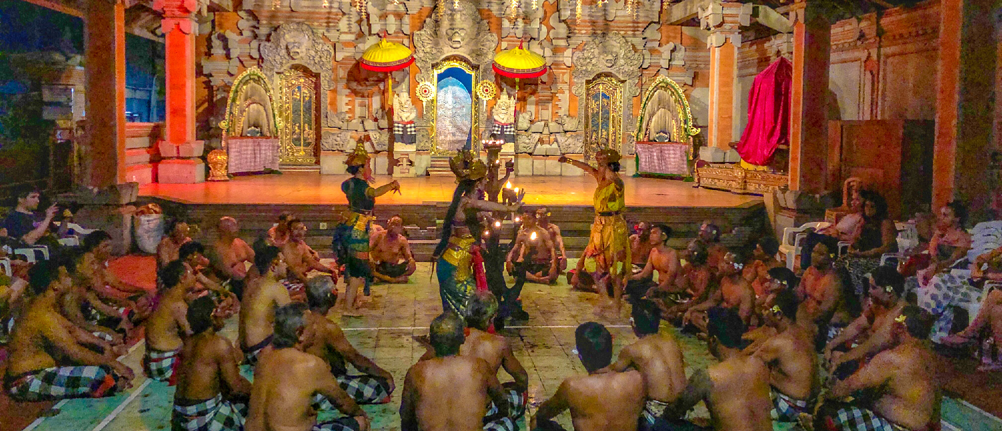 Balinese dancers perform a traditional Kecak fire dance for an audience at a temple in Ubud.