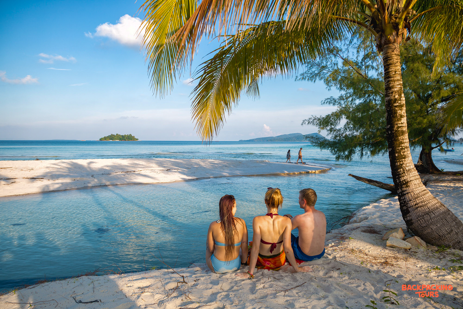 Friends relax on a beautiful sunny beach in Koh Rong, enjoying the tropical island paradise.