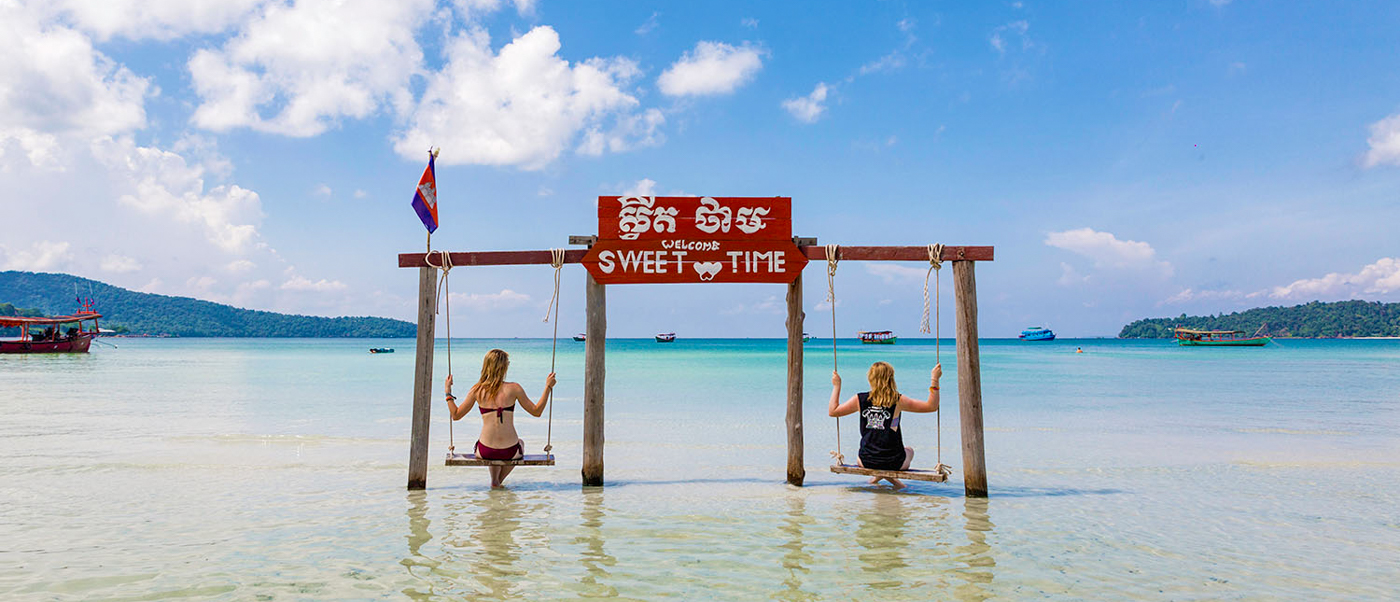 Tourists enjoy a "Sweet Time" on swings in the clear blue waters of Koh Rong.