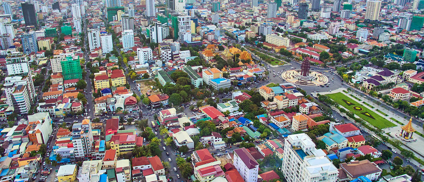 An expansive aerial view of Phnom Penh, Cambodia, showcasing its diverse buildings and bustling streets.