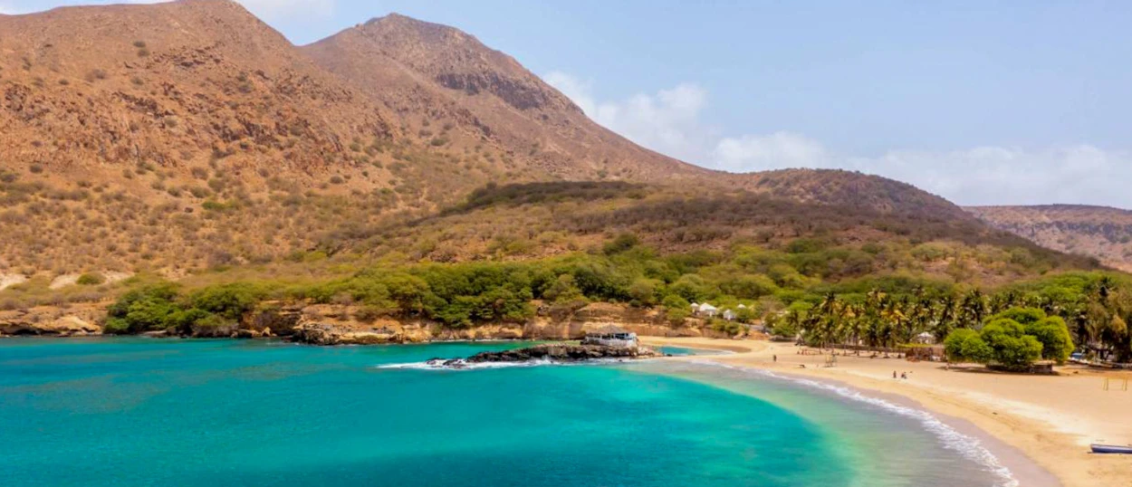 Stunning Cape Verde bay with turquoise water, a golden beach, and arid mountains.