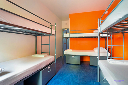 Metal bunk beds and lockers in a dorm room at the Amsterdam hostel
