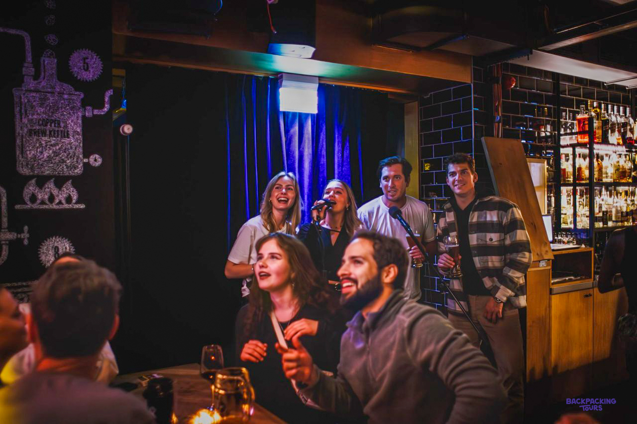Travellers laughing together in the bar of the Berlin hostel