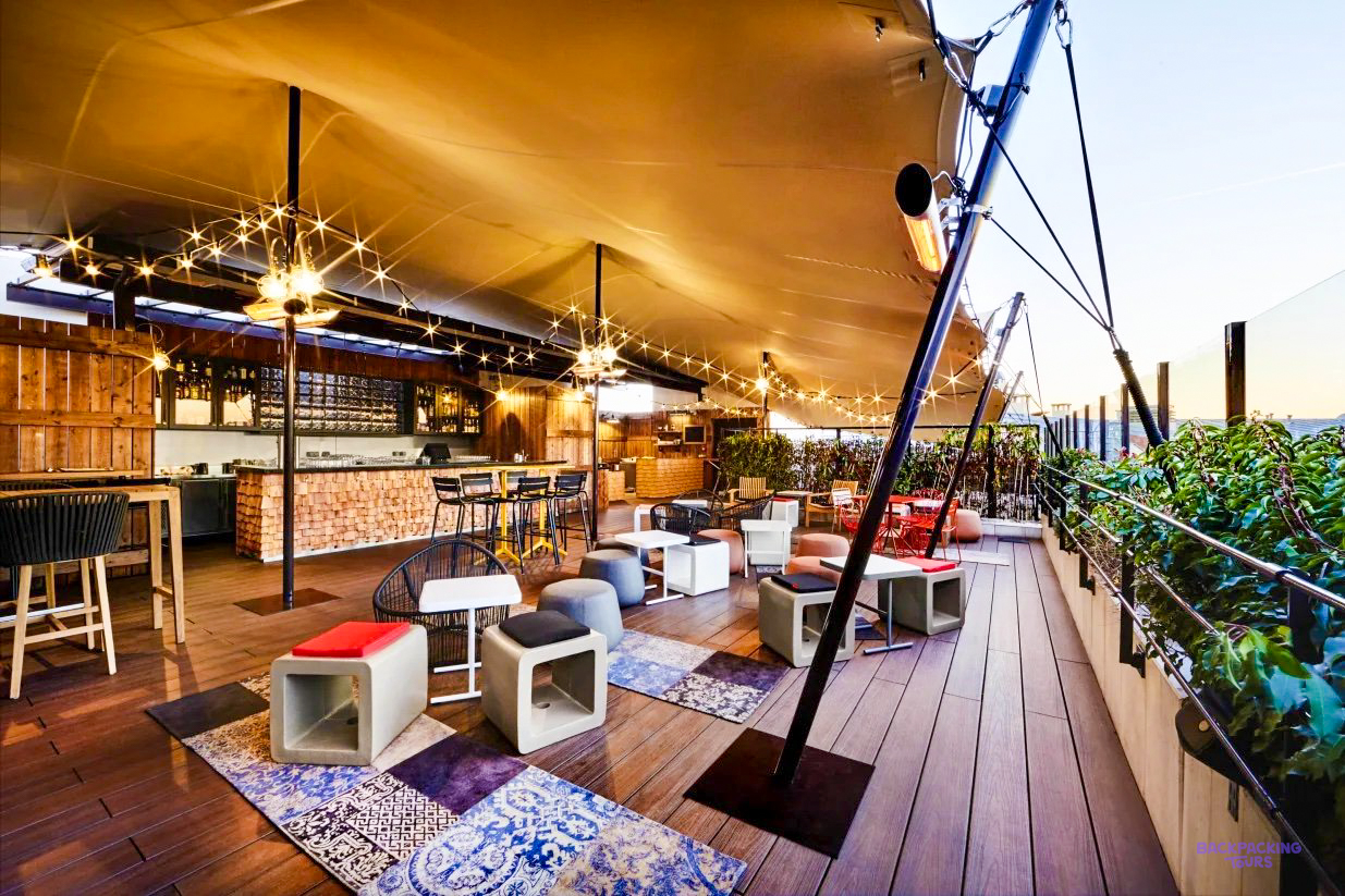 The rooftop bar of the Paris hostel, with fairy lights and low seating