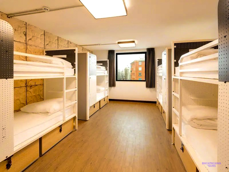 White wooden bunk beds in a dorm room at the Paris hostel