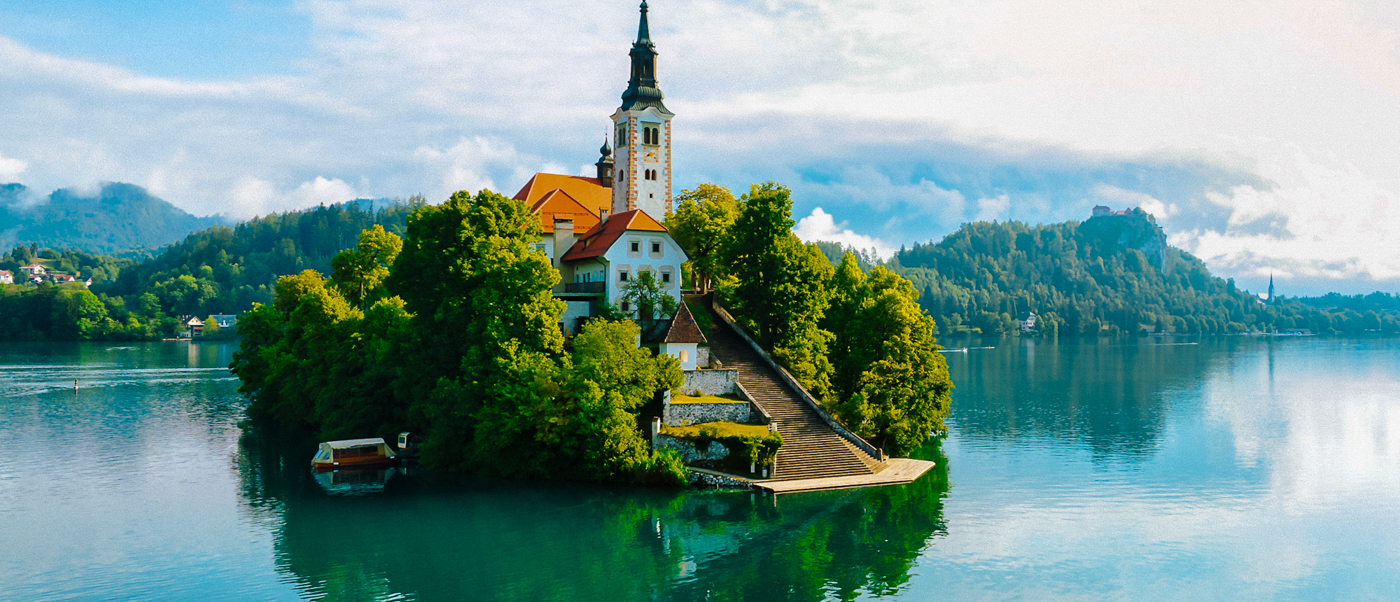 The church on Bled Island rises from the trees in the middle of Lake Bled.
