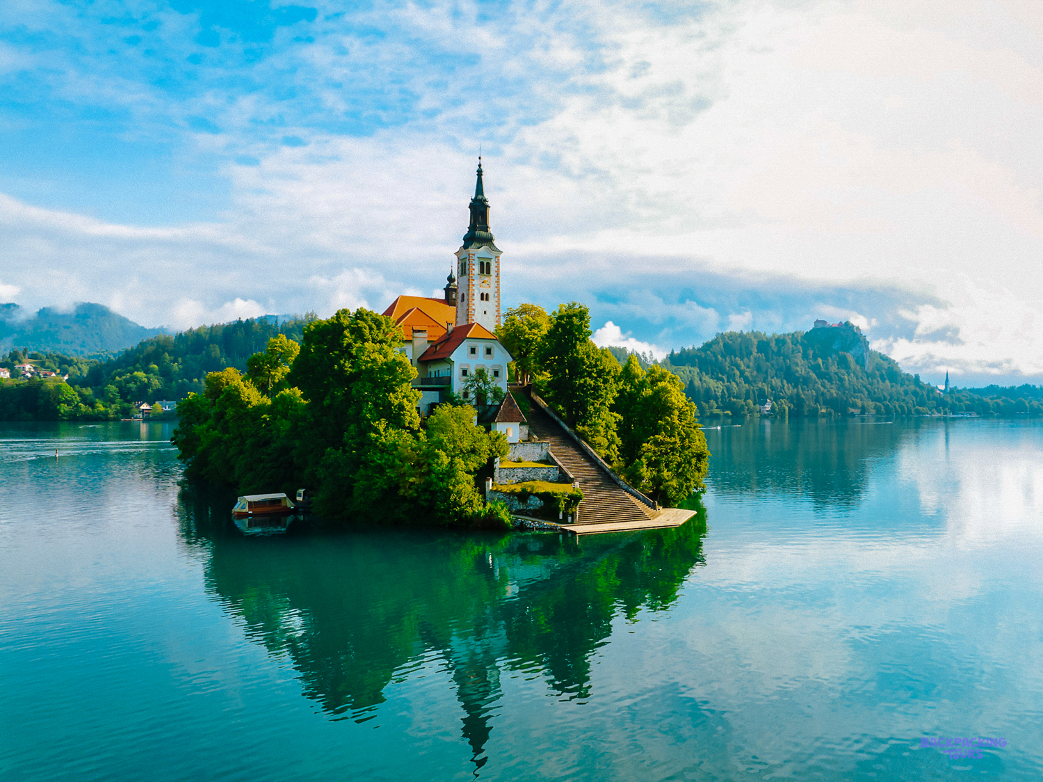 The church on Bled Island rises from the trees in the middle of Lake Bled.