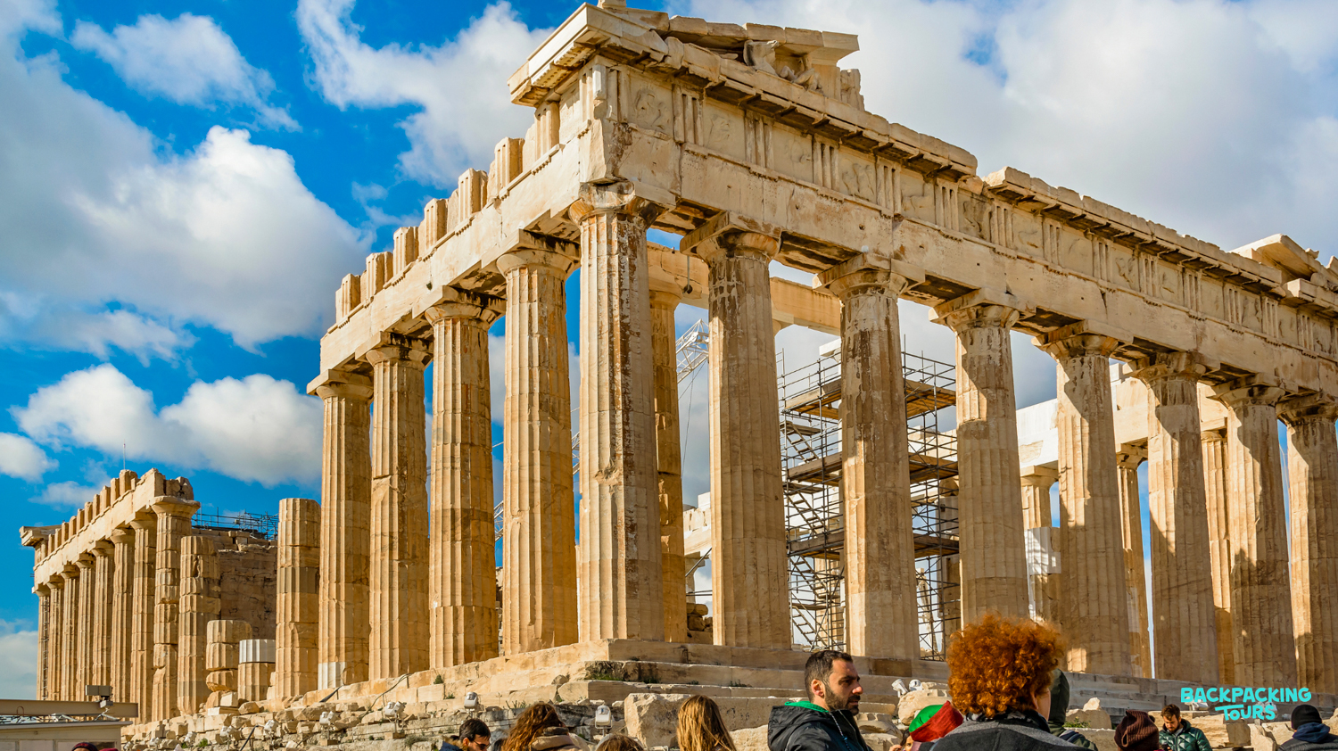 Tourists gather to admire the magnificent Parthenon temple, a historical marvel in sunny Athens.