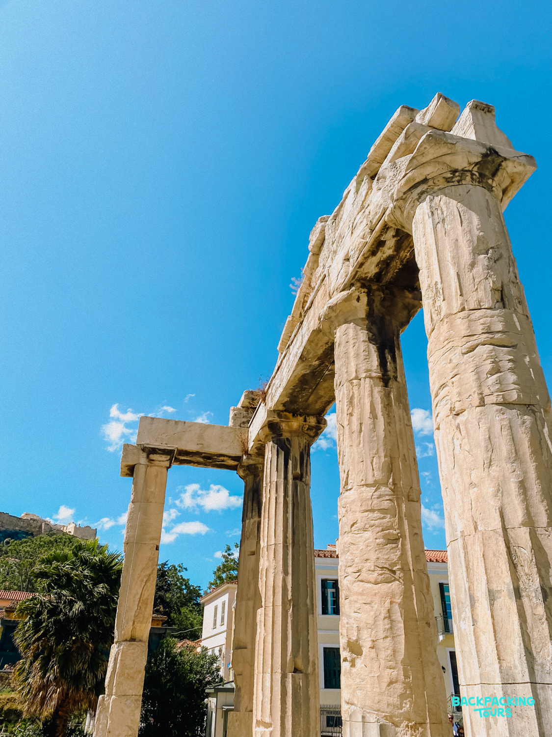 Towering ancient columns stand proudly under a clear blue sky in historic Athens.