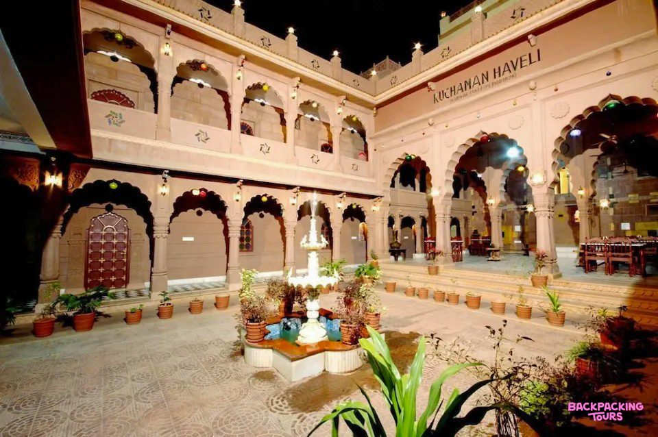 An inviting traditional haveli courtyard in Jodhpur, beautifully lit at night with a central fountain.