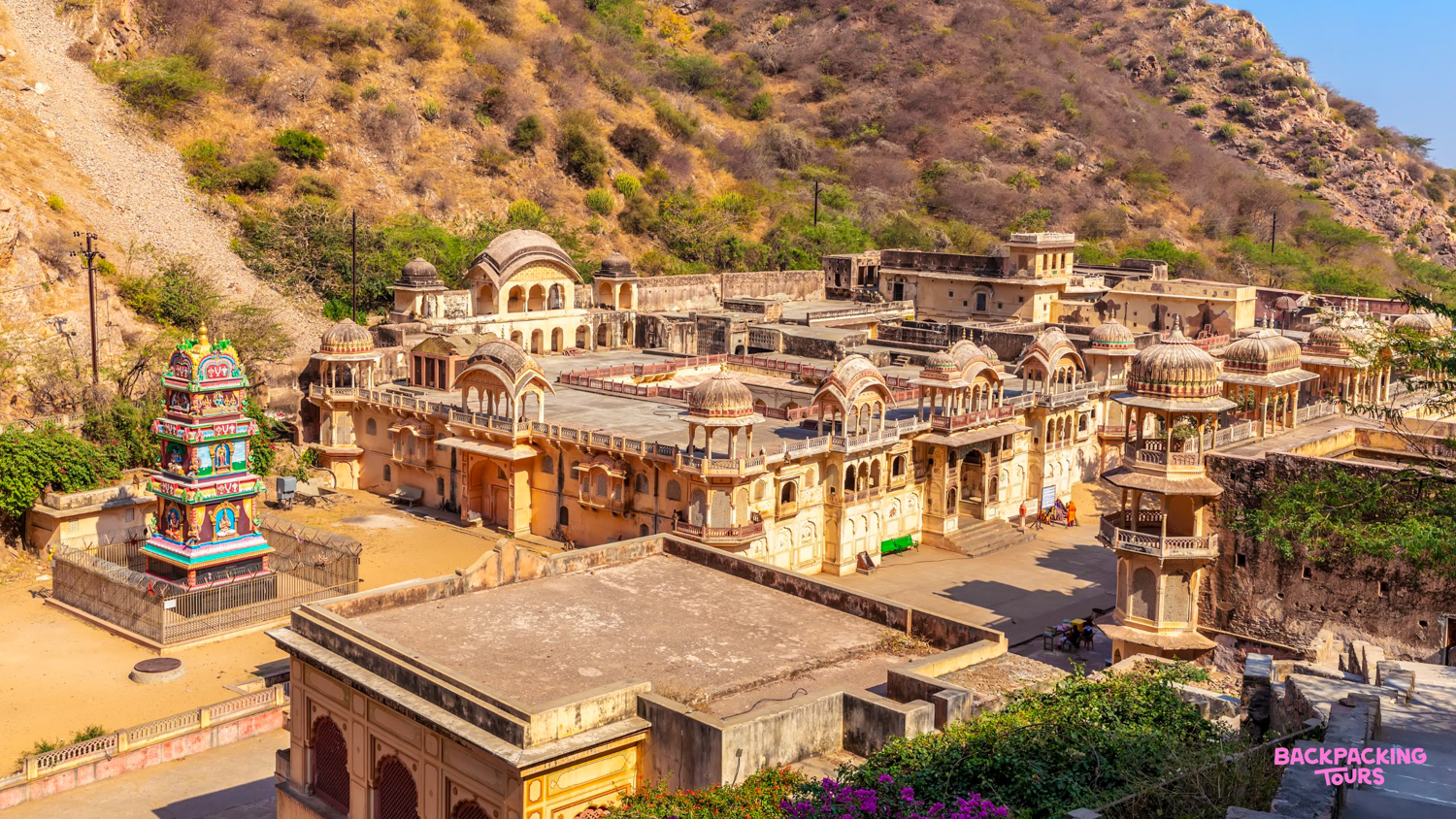 Overhead view of the historic Galta Ji Monkey Temple complex in Jaipur, nestled in arid hills.