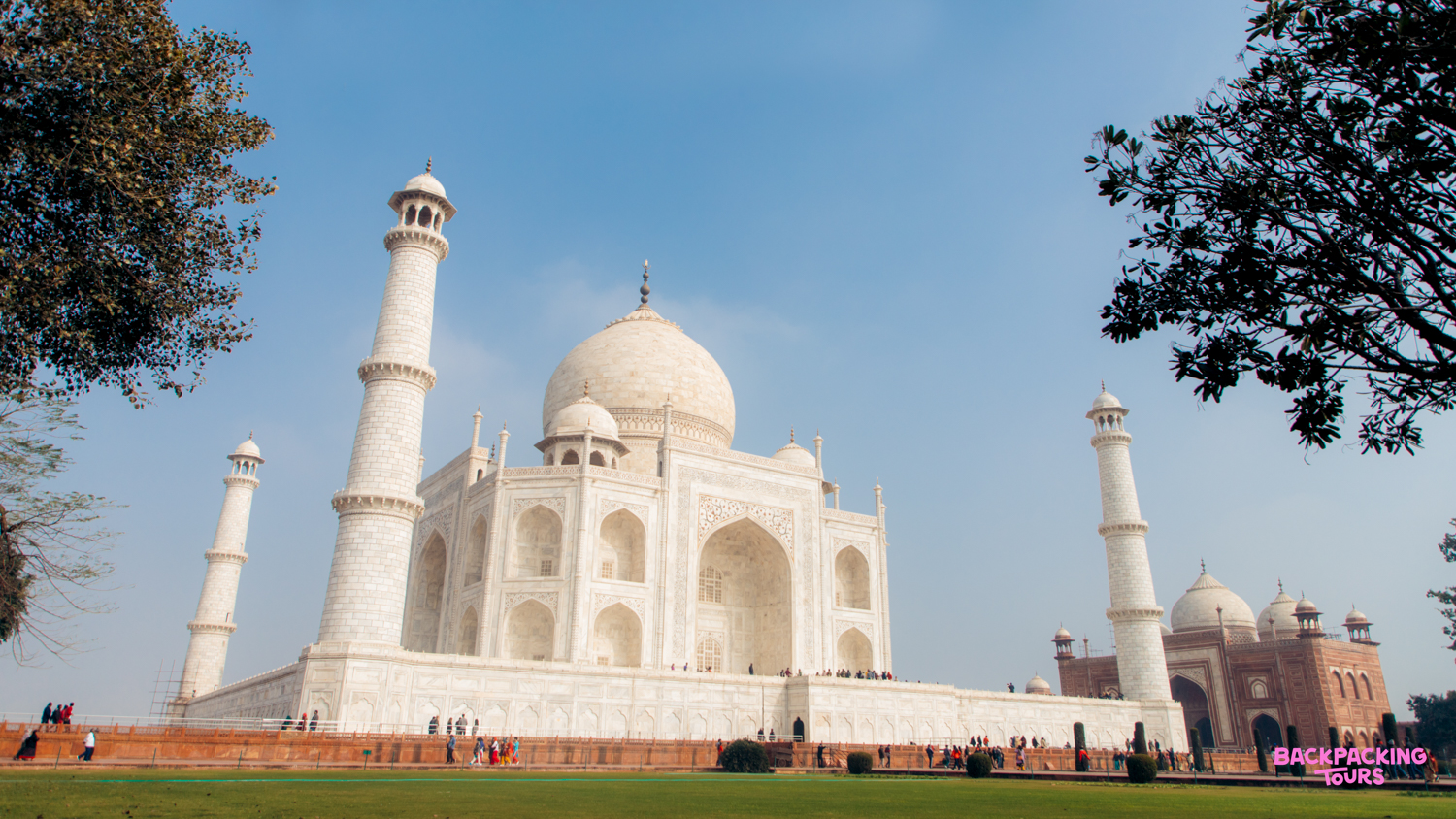The breathtaking Taj Mahal in Agra gleams white under a brilliant blue sky.