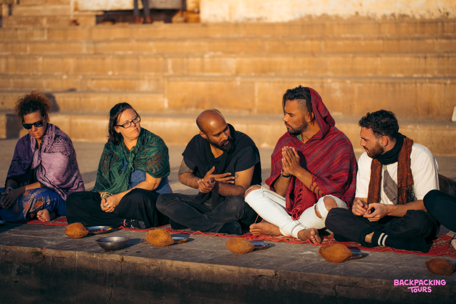 Travelers receive a traditional blessing by the sacred Pushkar Lake in India.