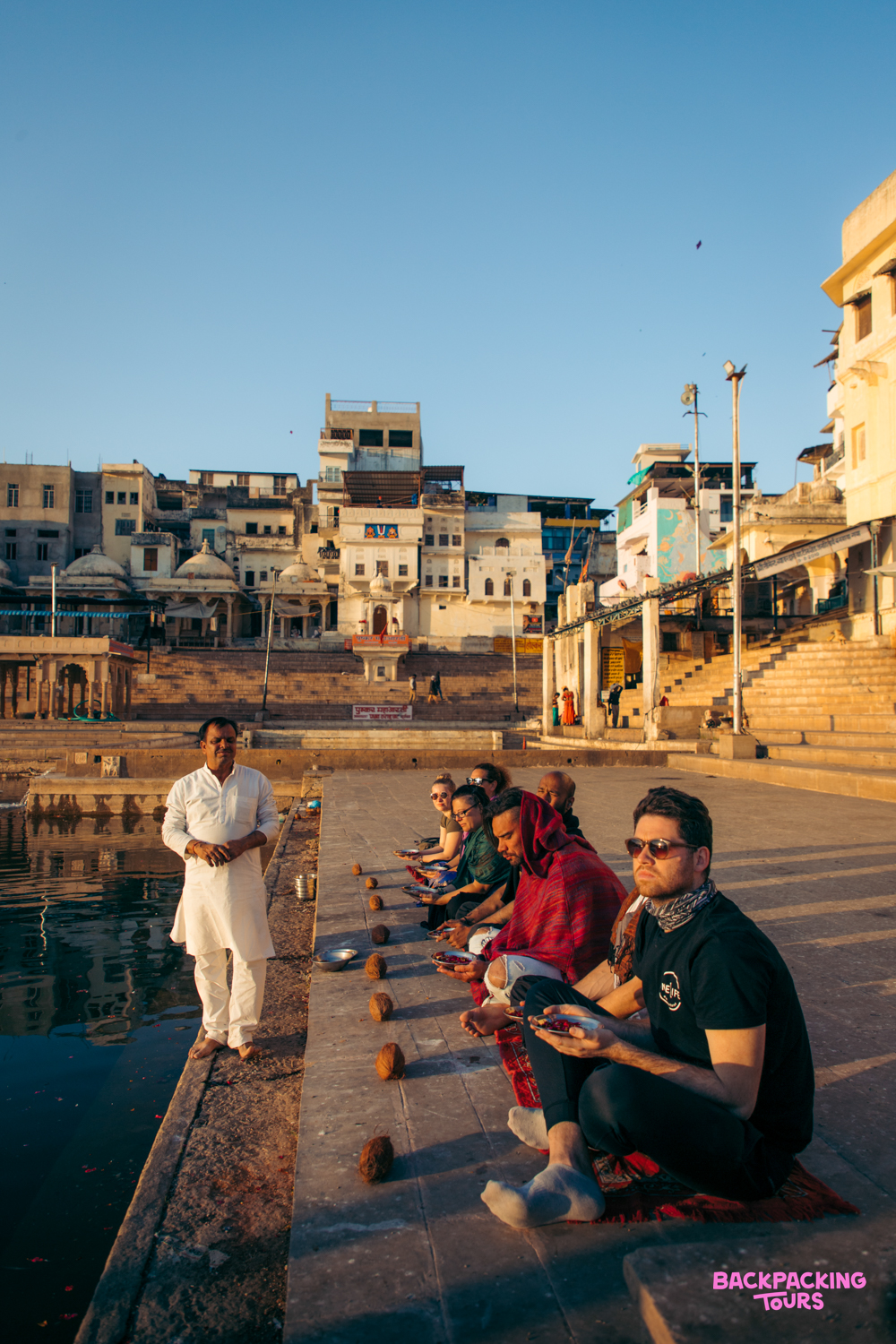 Tourists receive a traditional blessing by a Brahmin on the ghats of Pushkar lake.