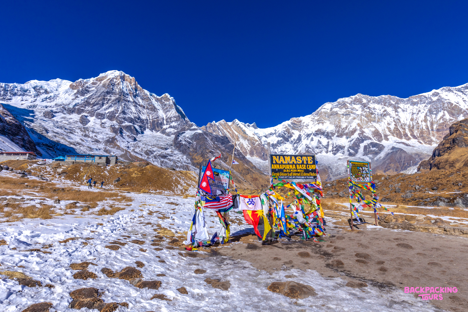 Stunning view of the Annapurna Mountain Range from Annapurna Base Camp, adorned with vibrant prayer flags.