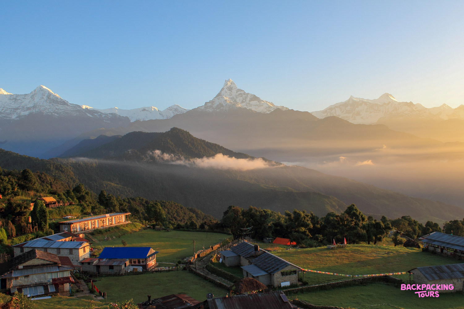 Golden light illuminates Australian Camp village with the majestic Annapurna Mountain Range at sunrise.