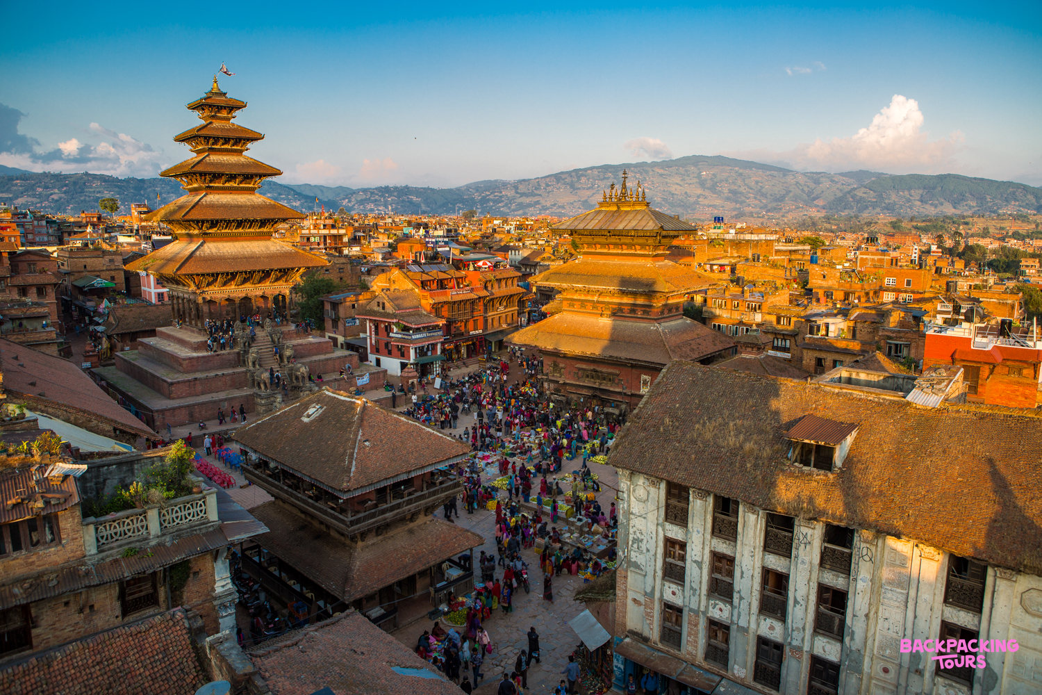 A vibrant aerial view of Kathmandu Durbar Square bustling with people and historic pagoda temples.